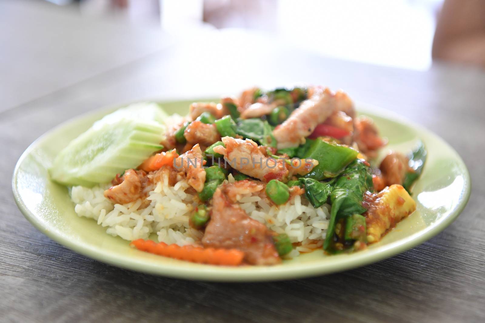 Stir fried pork and curry paste on rice, Thai food.