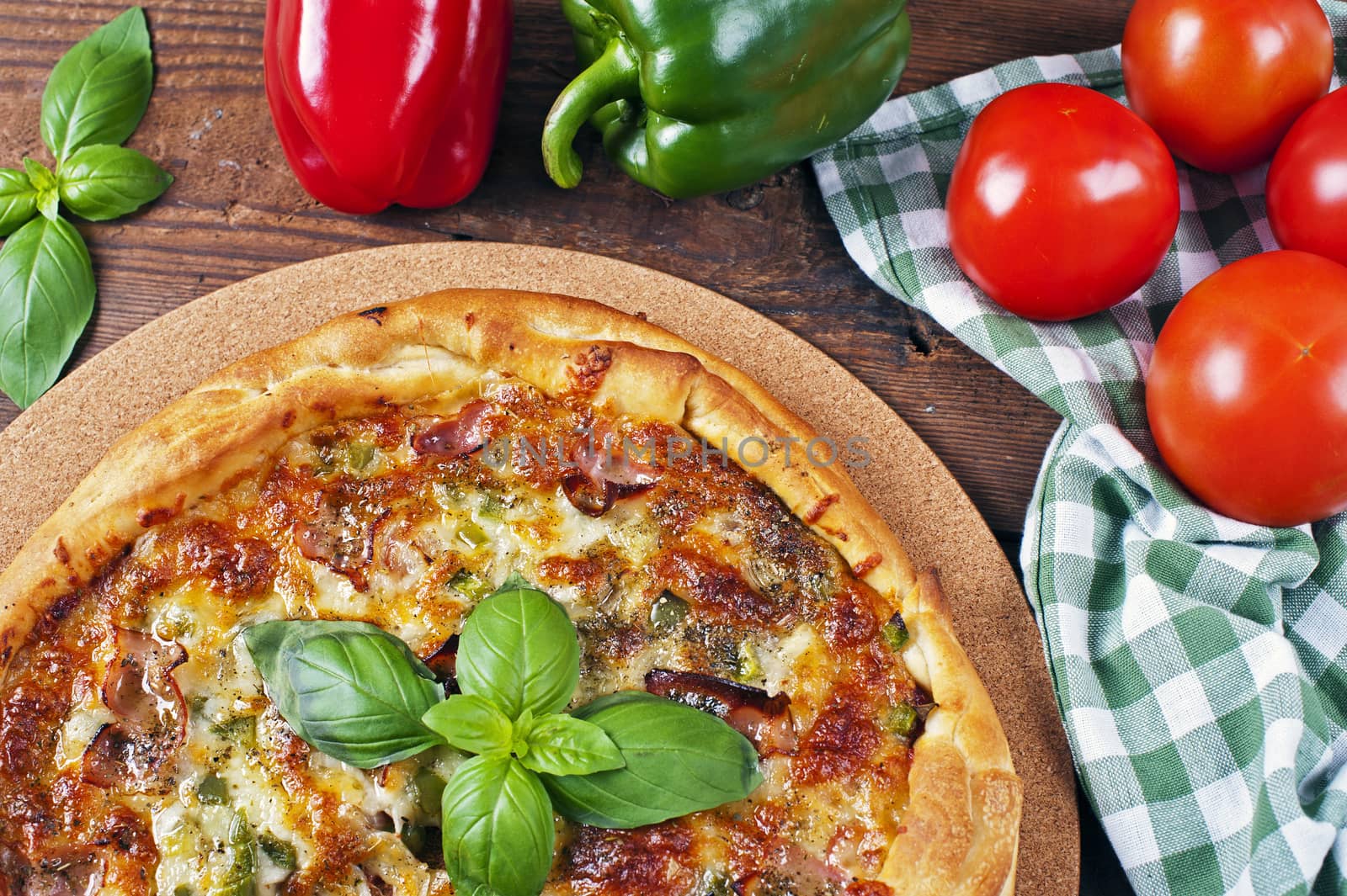 Italian homemade pizza with bacon on a wooden table