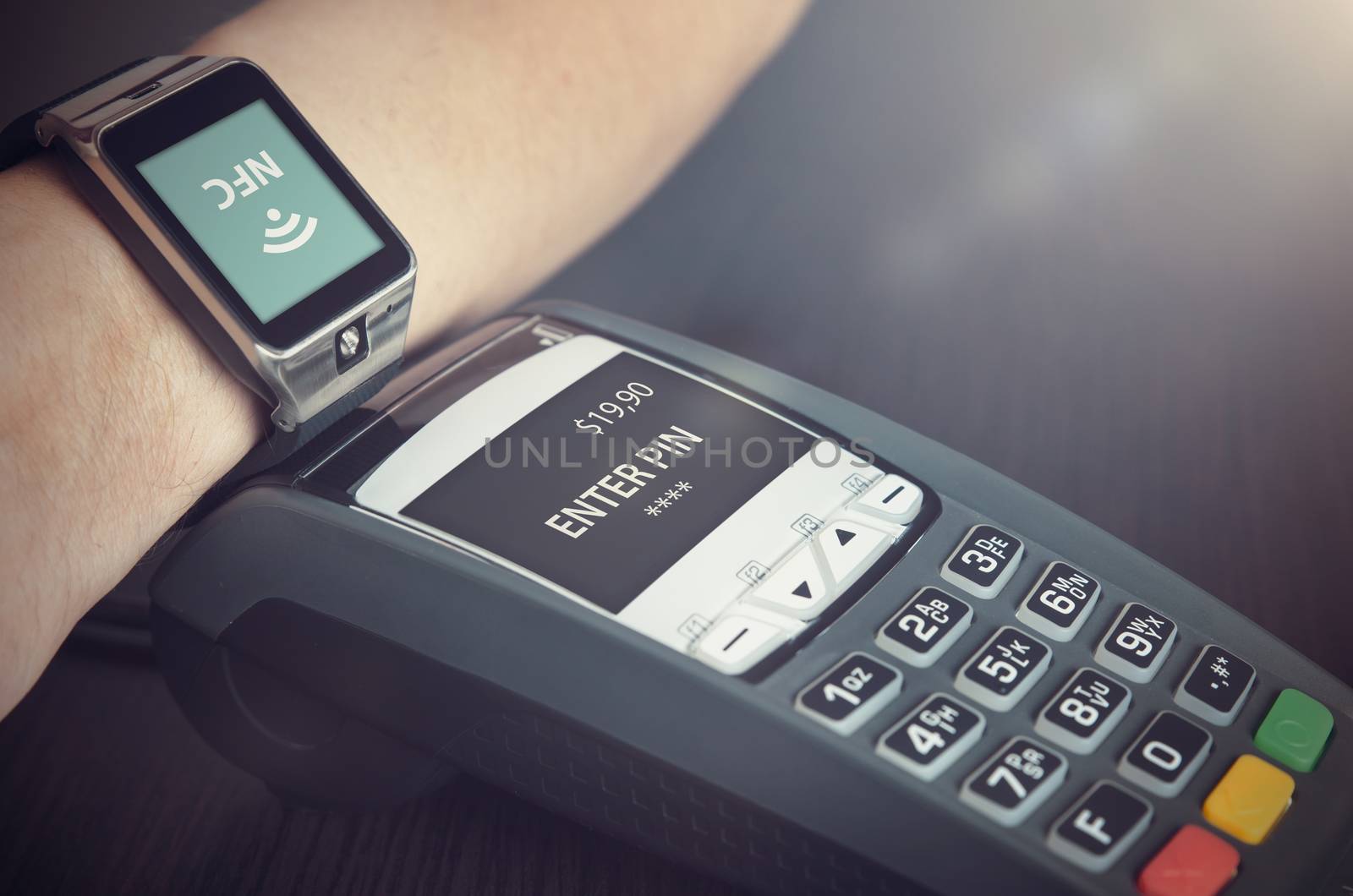 Man making payment through smartwatch via NFC contactless technology
