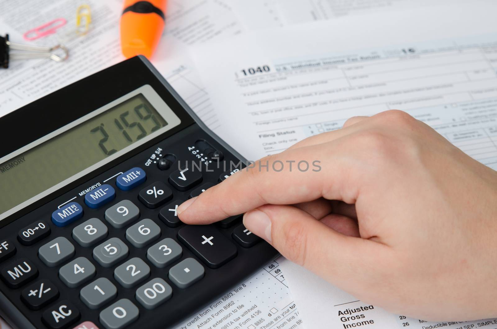 Man calculates income tax. tax form us calculate income office hand refund concept