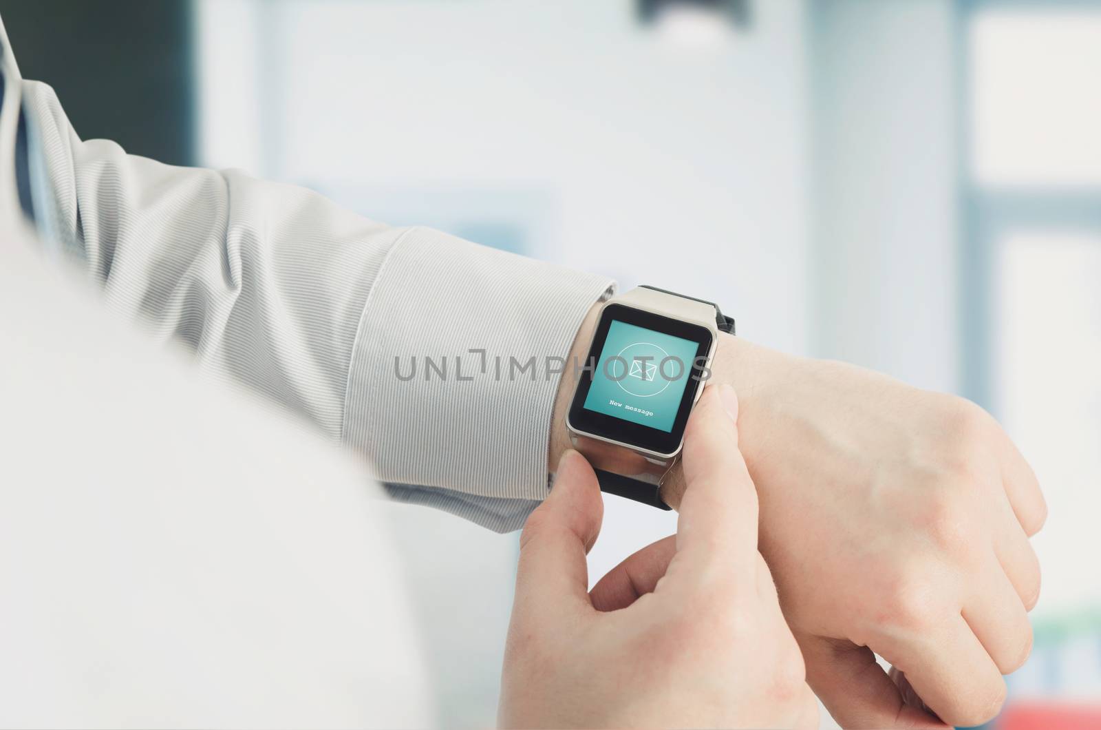 Man using smartwatch with e-mail notifier by simpson33