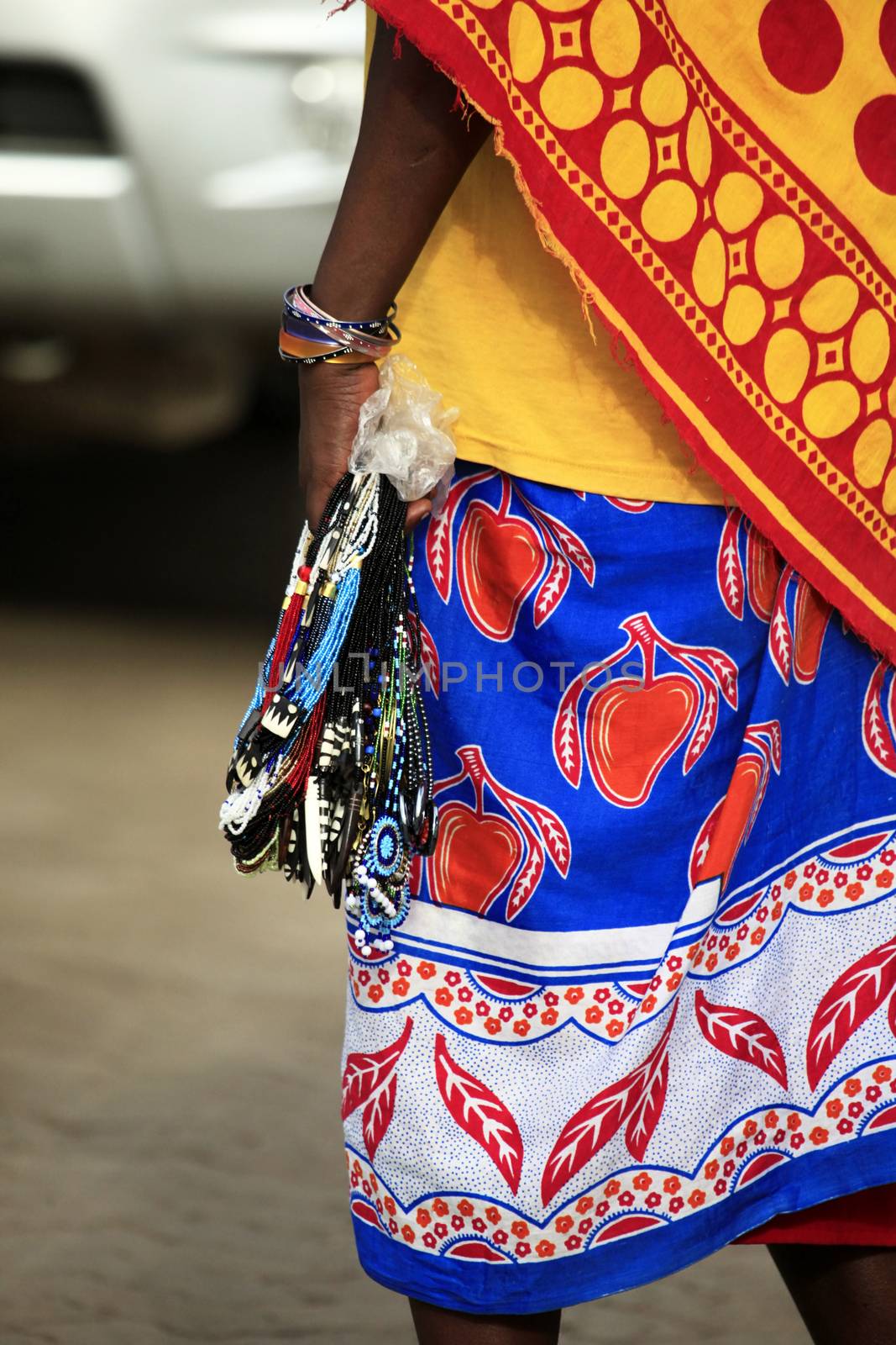 Massai woman sells souvenirs to tourists by friday