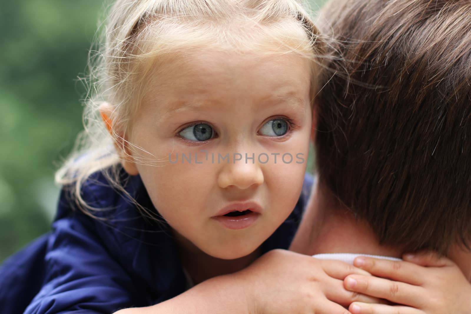 Little frightened girl hugging father