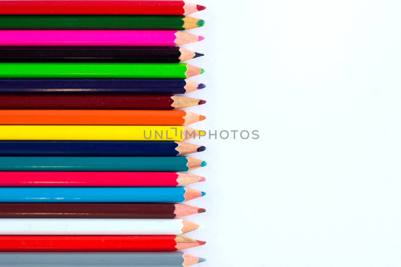 White background for presentation with vertical colourful right border of multicoloured wooden pencils
