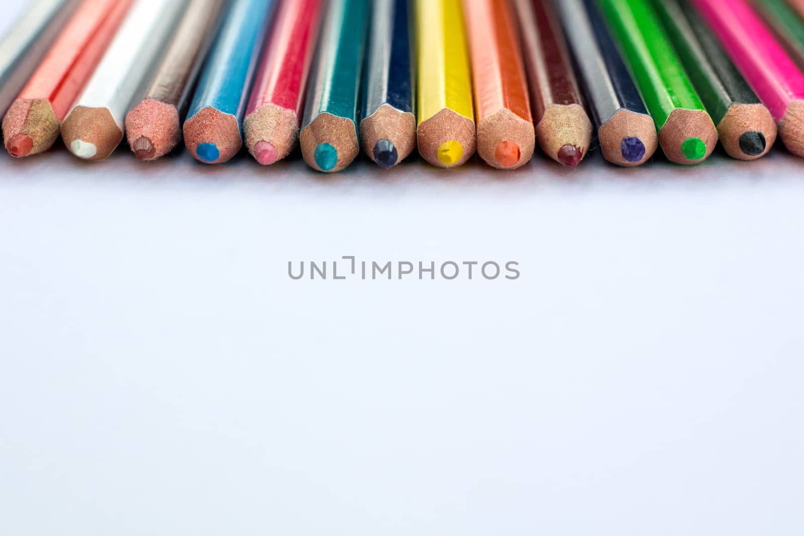 White background for presentation slide with colourful wooden pencils