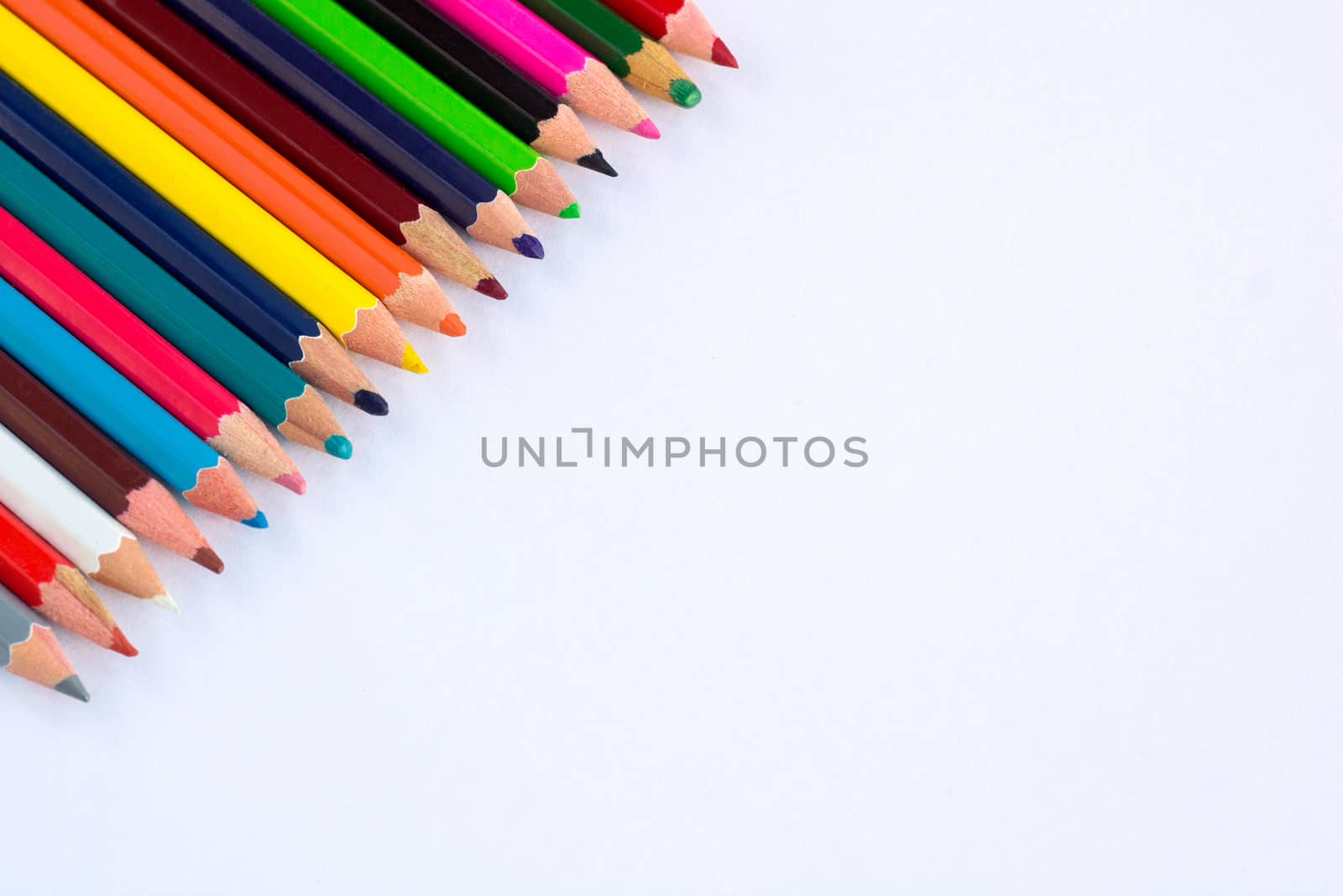 White background for presentation with colourful right upper corner of multicoloured wooden pencils