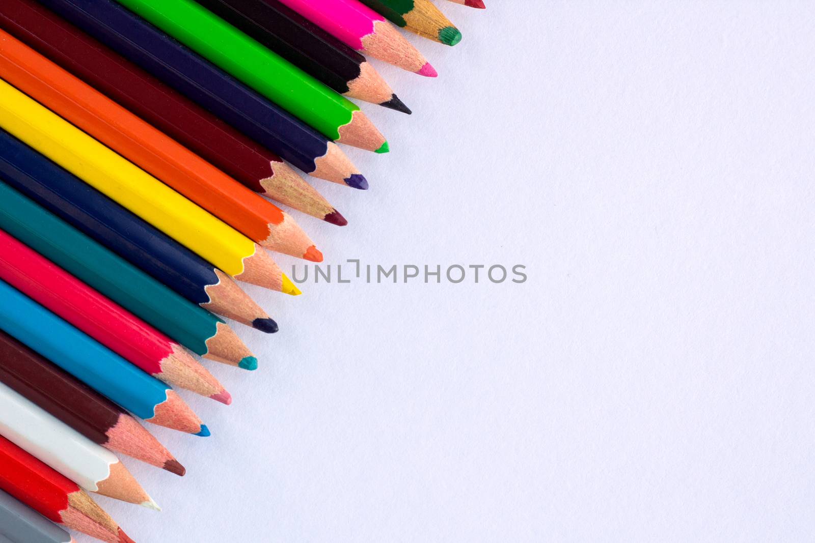 White background for presentation with colourful right upper corner of multicoloured wooden pencils