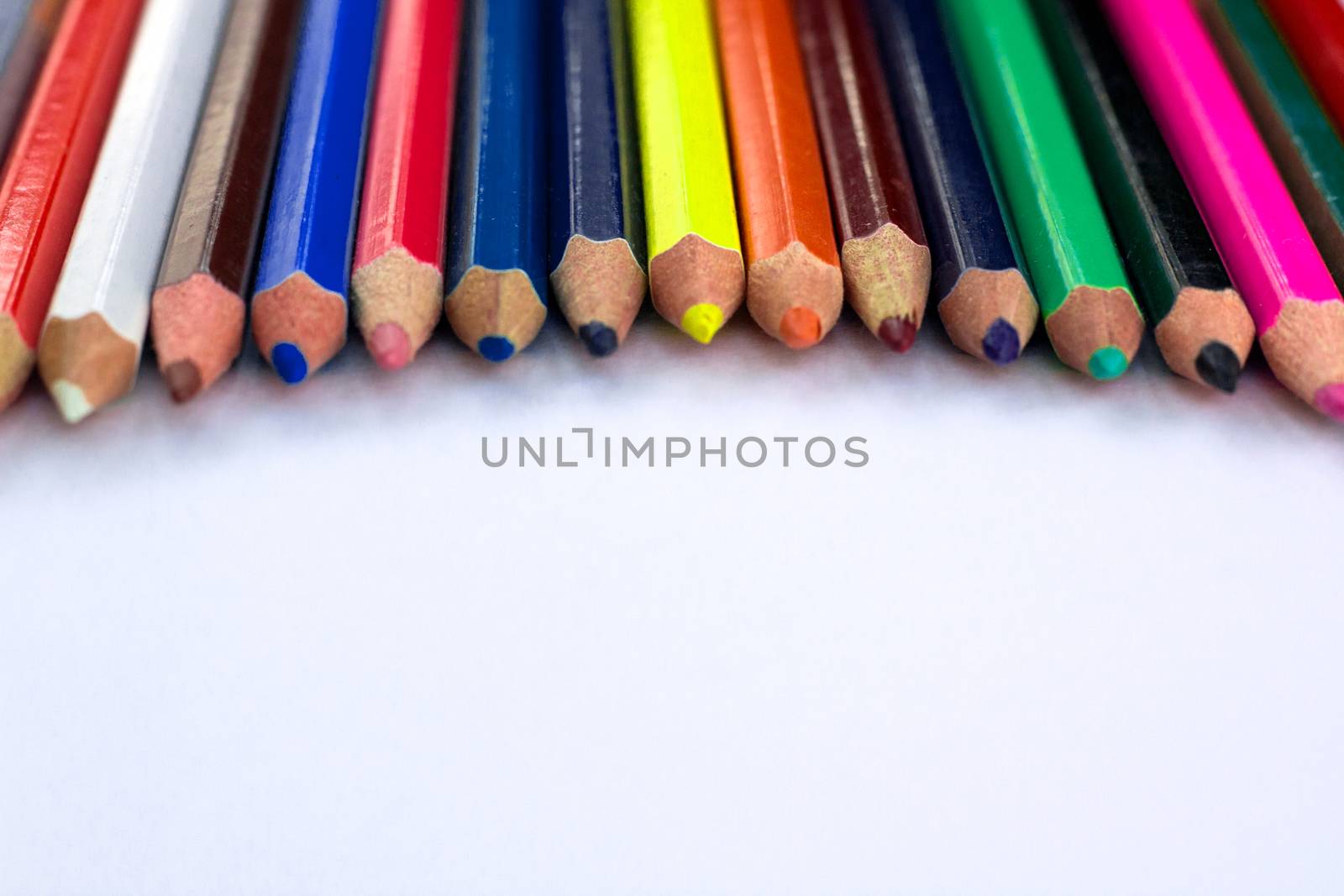 White background for presentation slide with colourful wooden pencils