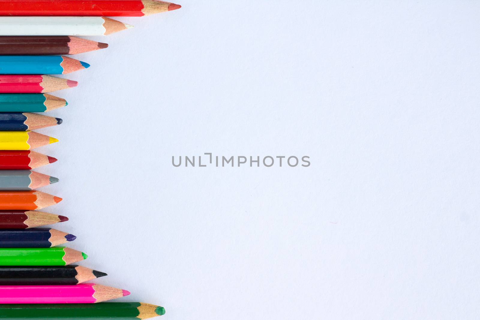 White background for presentation with vertical colourful right round border of multicoloured wooden pencils