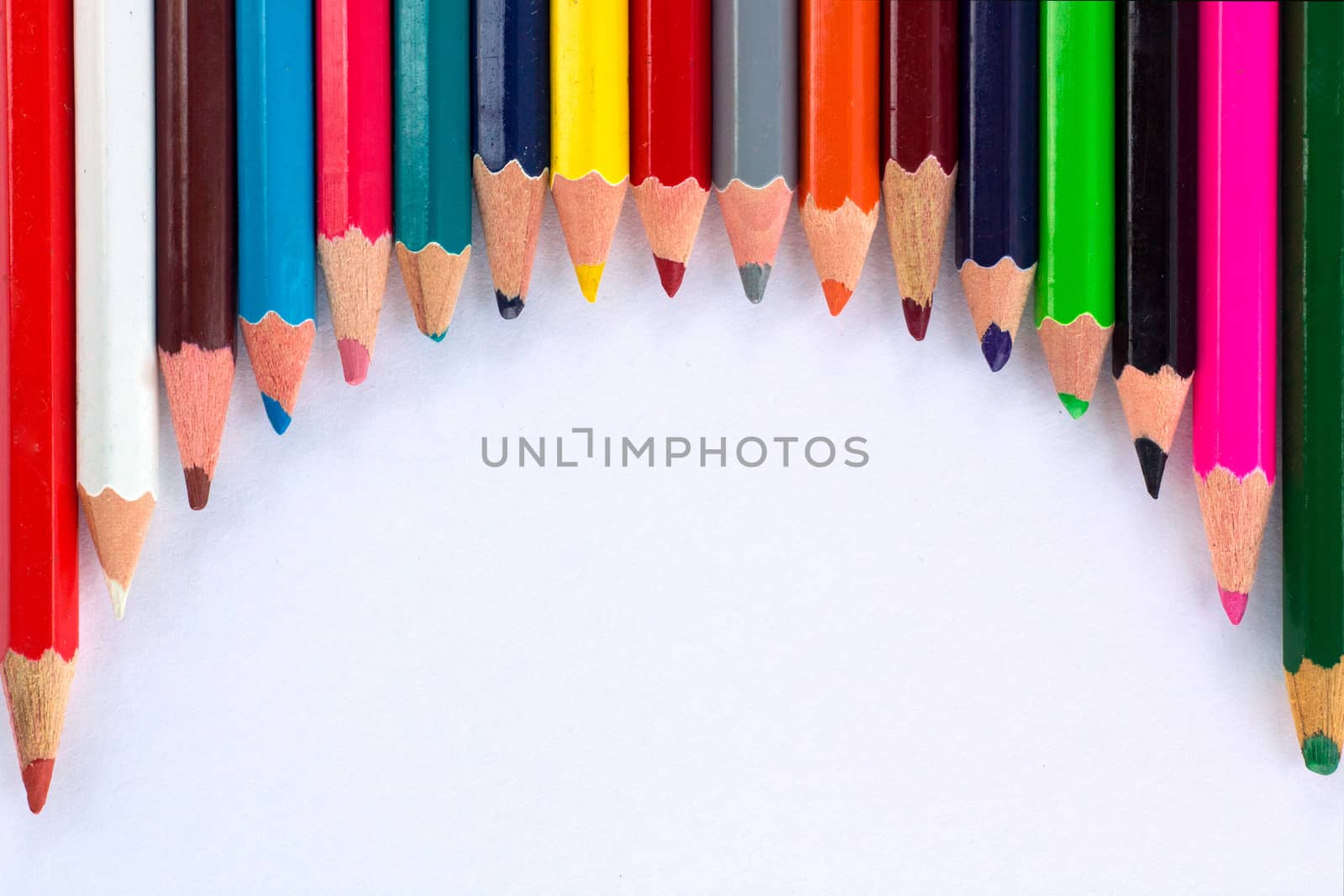 White background for presentation with round horizontal colourful upper border of multicoloured wooden pencils