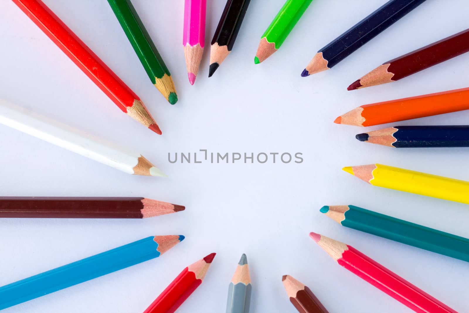 White background for presentation slide with colourful wooden pencils with circle copy space