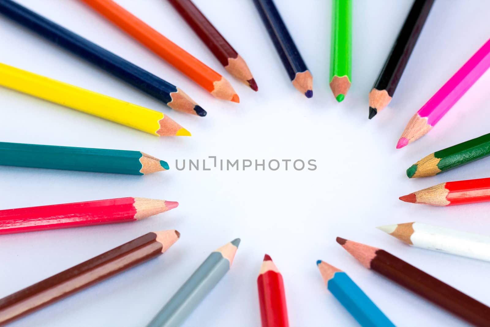 White background for presentation slide with colourful wooden pencils with circle copy space