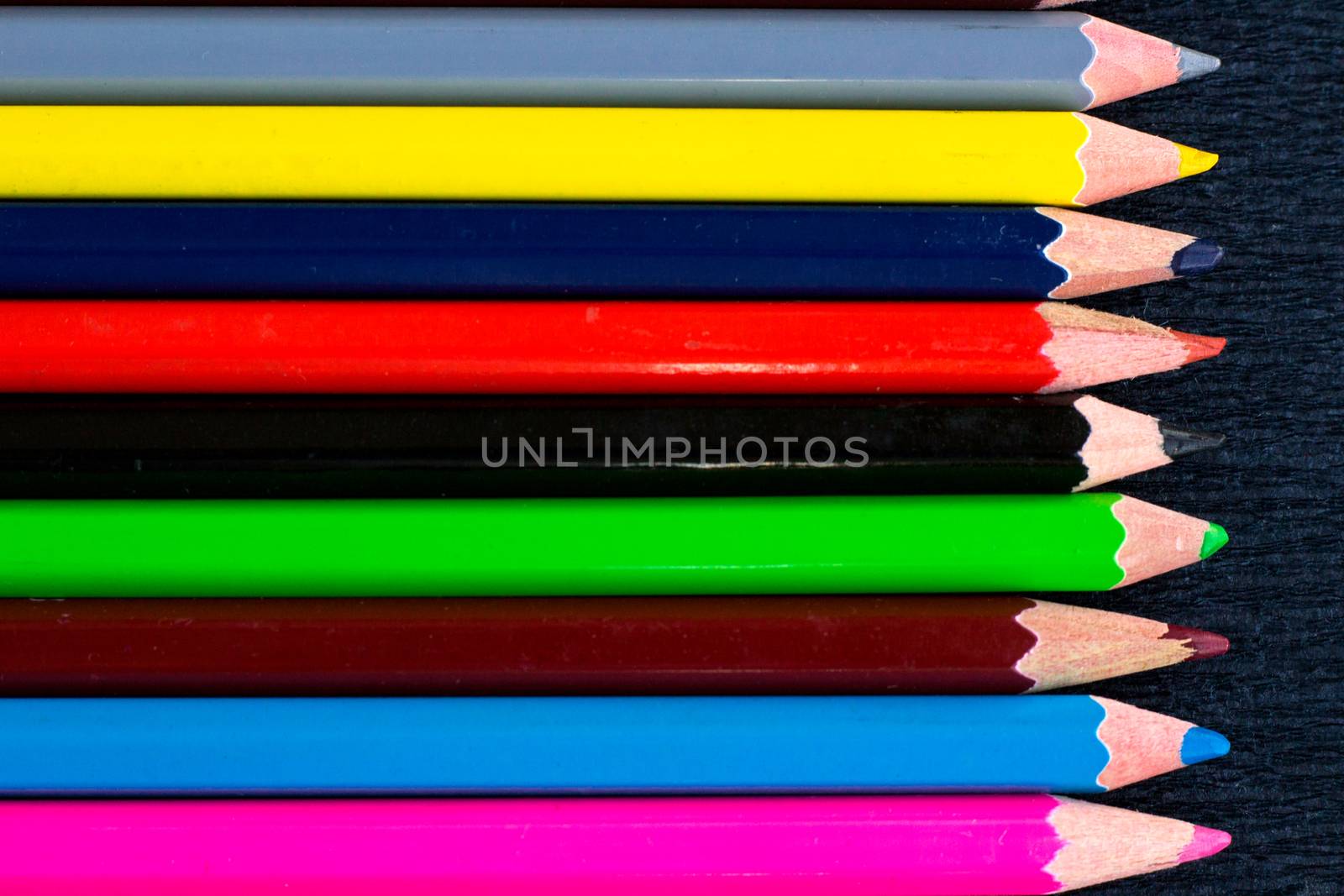 Horizontal colourful stripes of multicoloured wooden pencils background for presentations