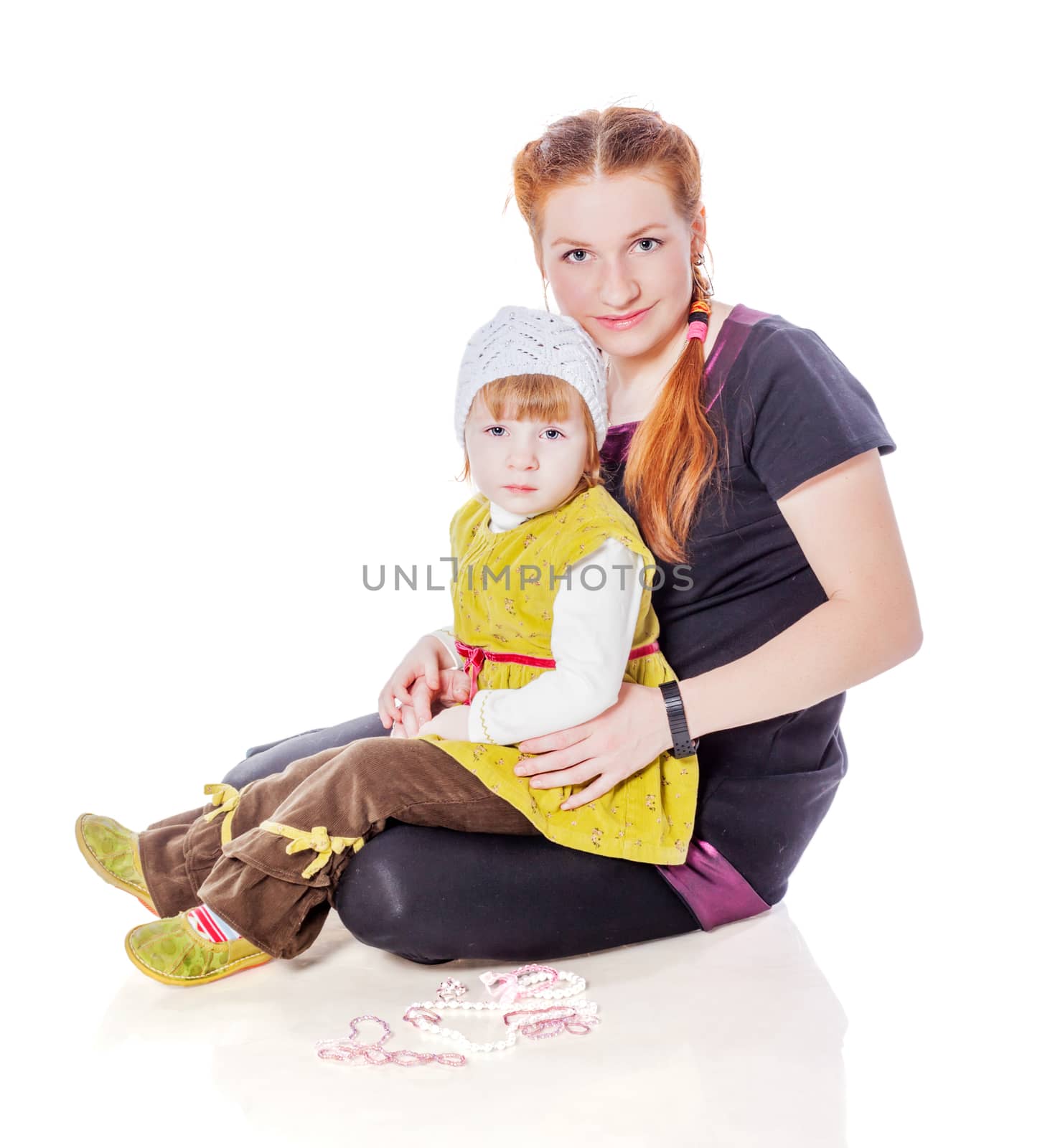 Mother sitting with toddler daughter isolated on white