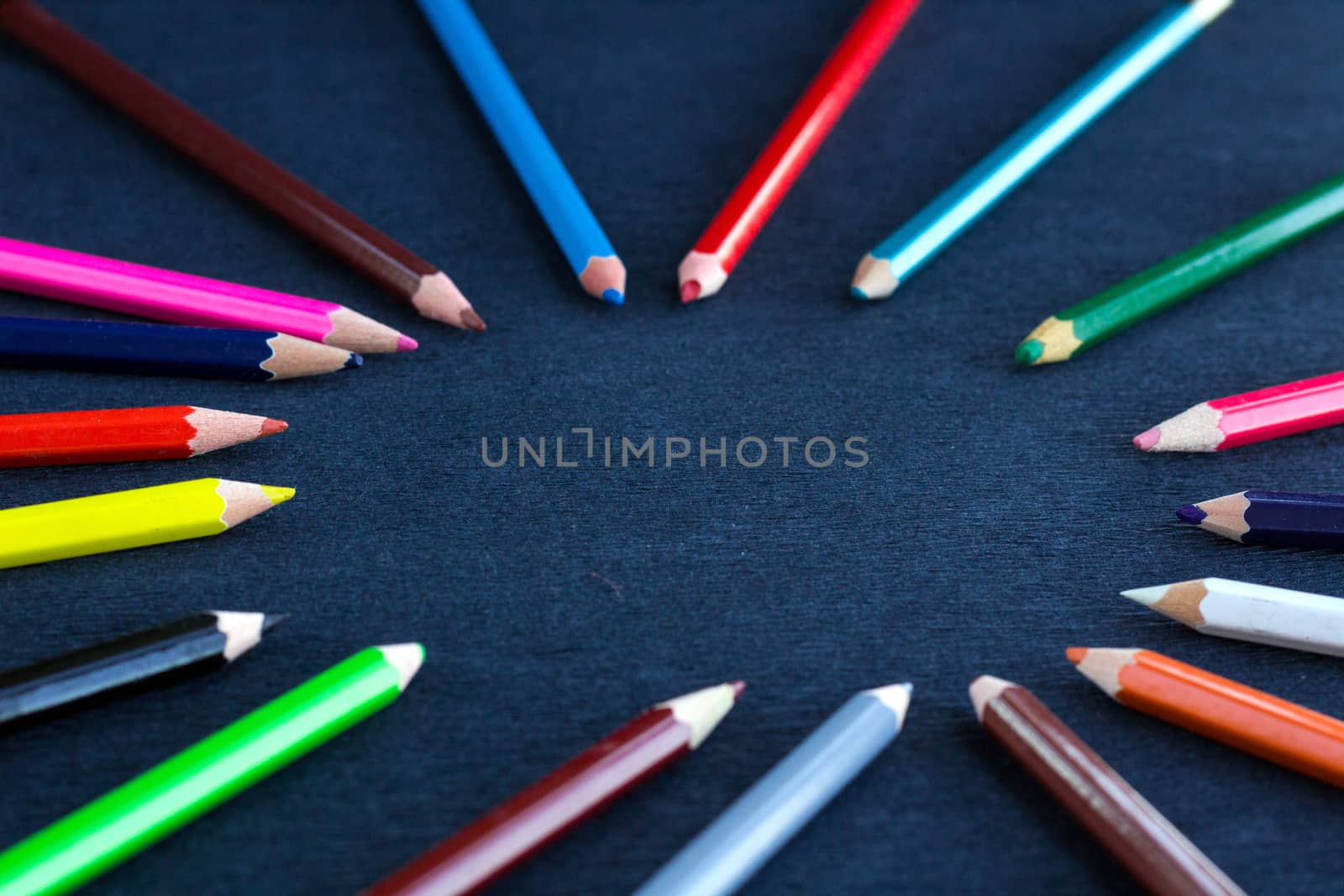 Black background for presentation slide with colourful wooden pencils with circle copy space