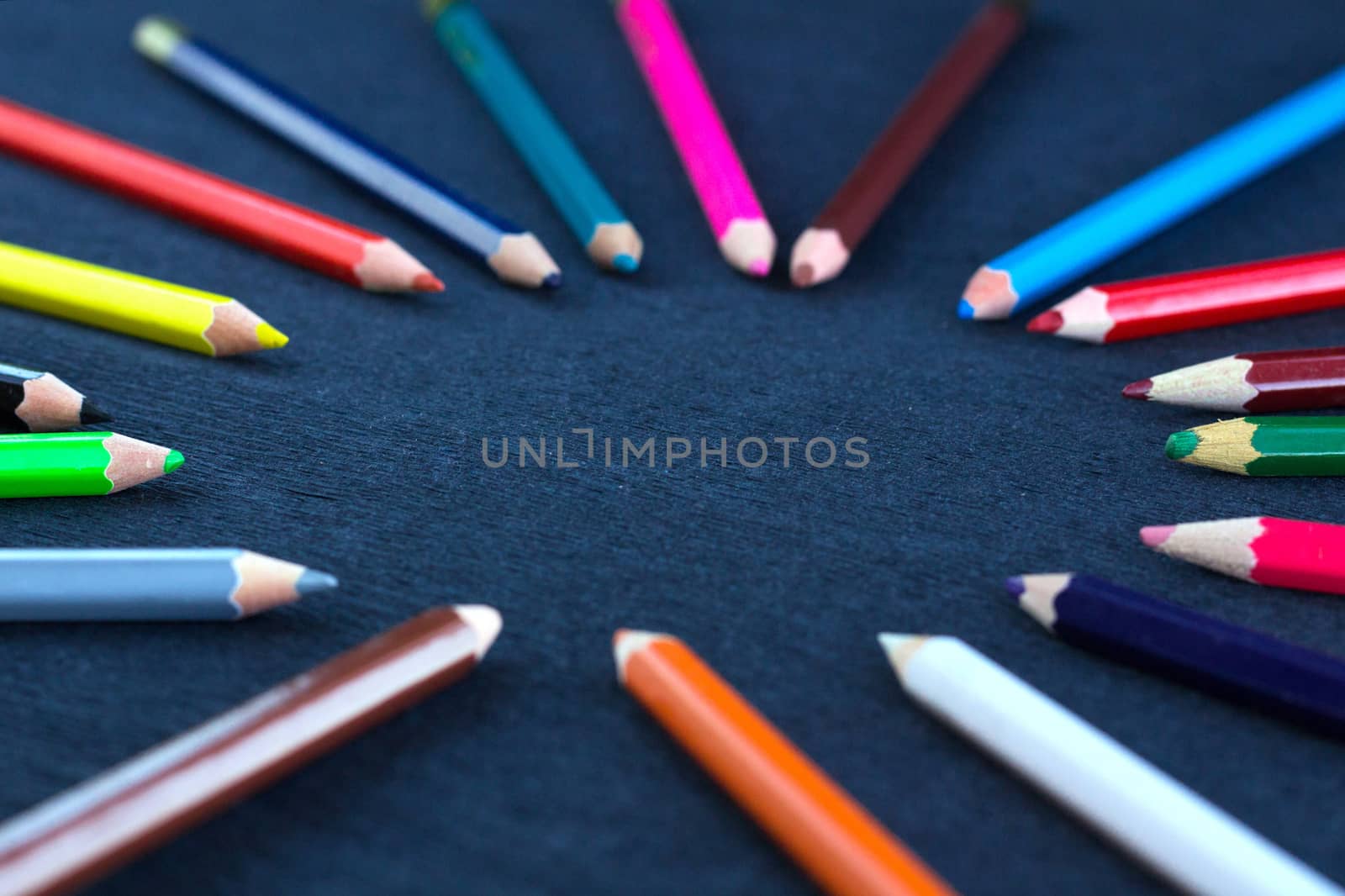 Black background for presentation slide with colourful wooden pencils with circle copy space