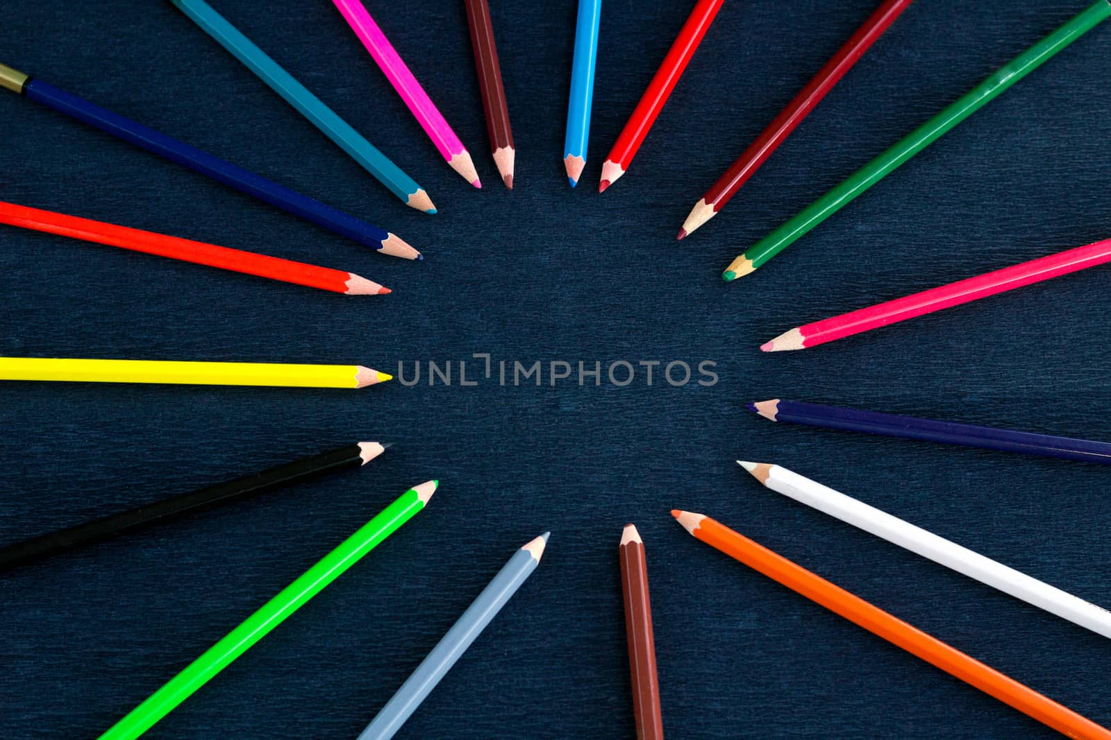 Black background for presentation slide with colourful wooden pencils with circle copy space