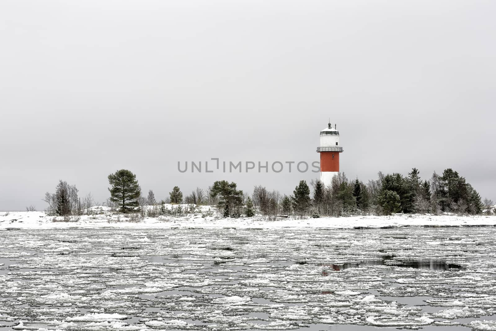 Light House with Icy Ocean and a cloudy sky.