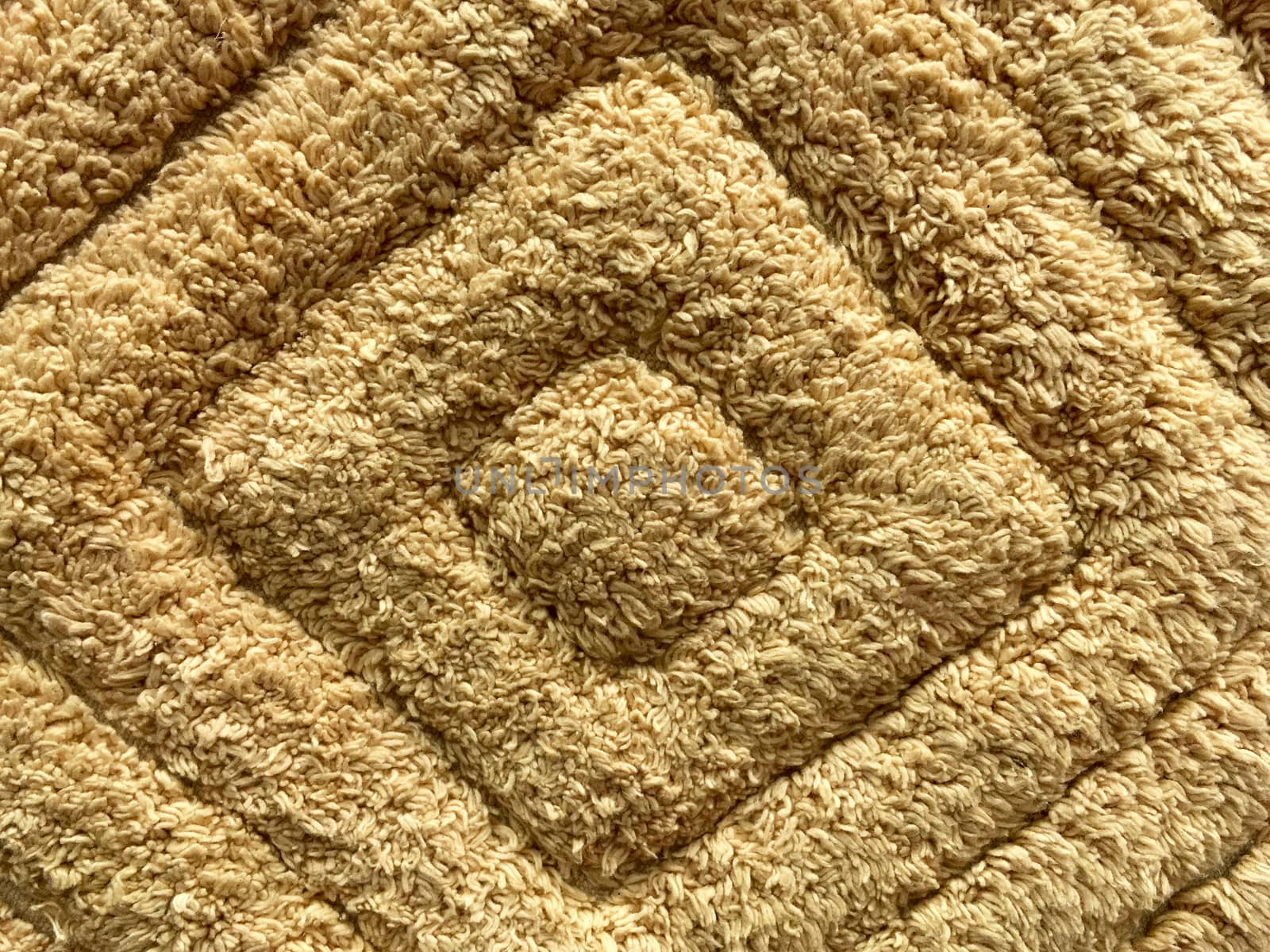 Close up of brown carpet texture and pattern.