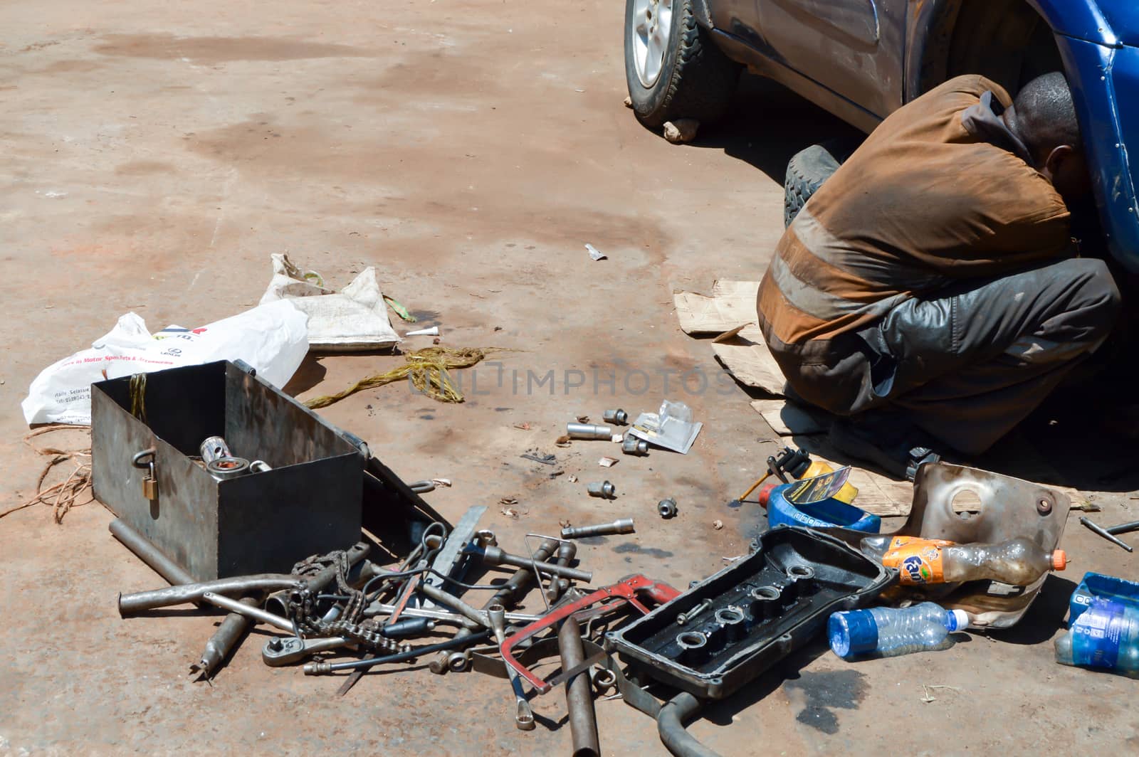 Mechanic car in full working on the floor on a parking lot in Kenya