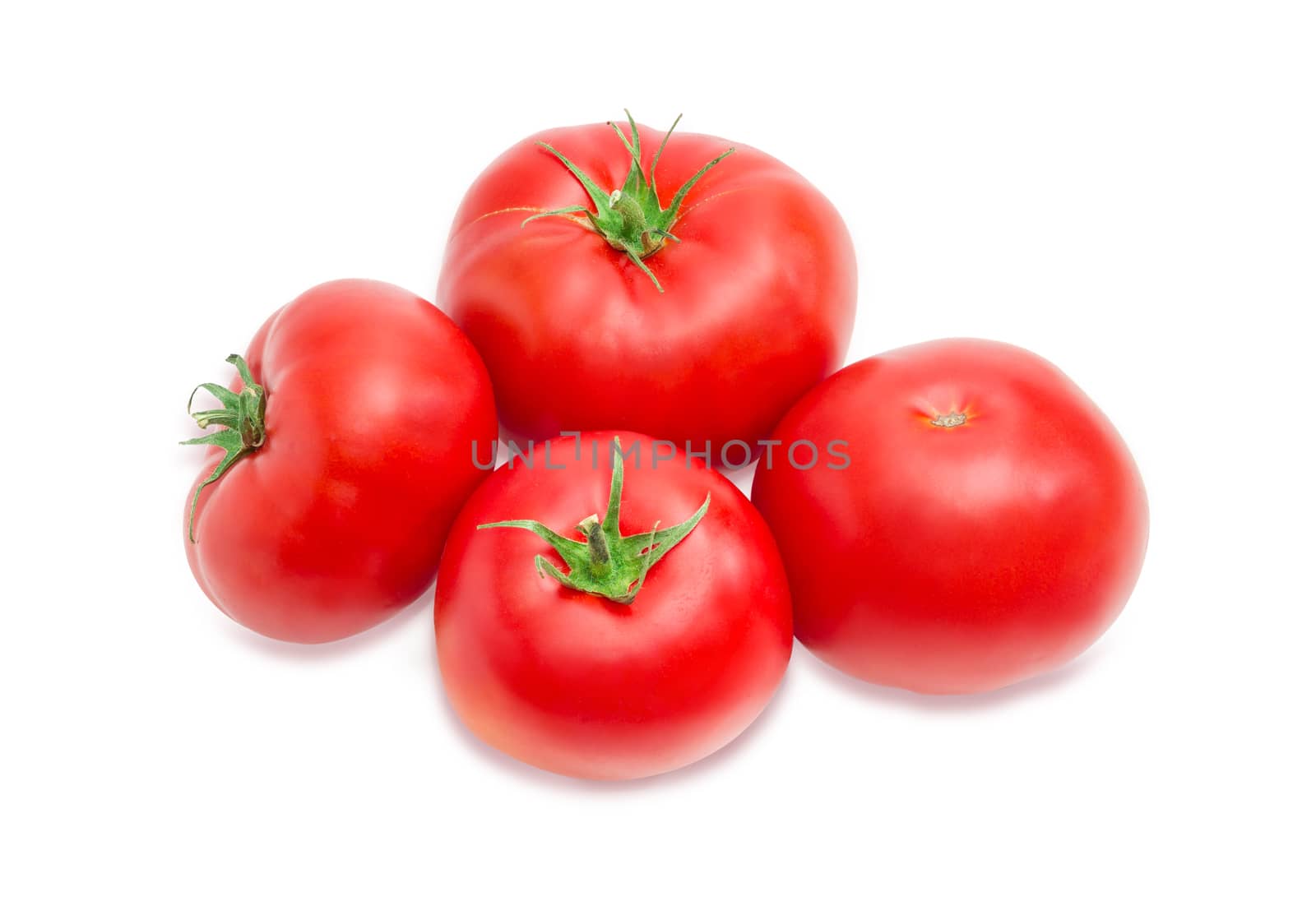 Several ripe red tomatoes closeup on a light background
