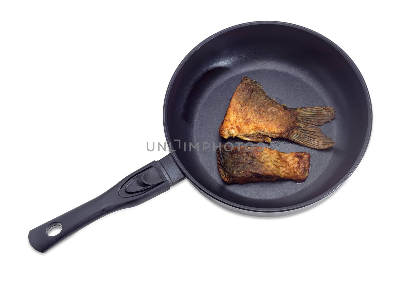 Fried tail portion and other slice of carp on an aluminium cast frying pan with ceramic non-stick coating on a light background
