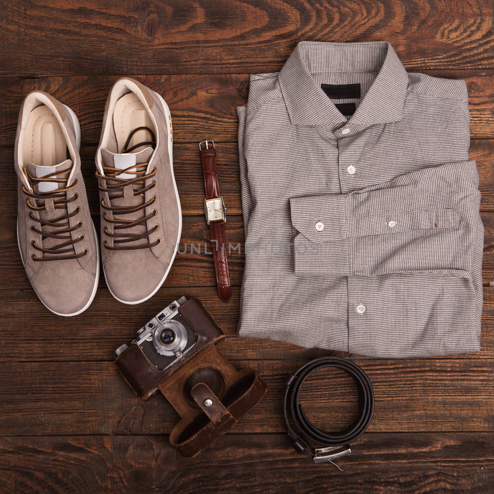 Flat lay of modern men's clothing on a brown wooden background. by natazhekova