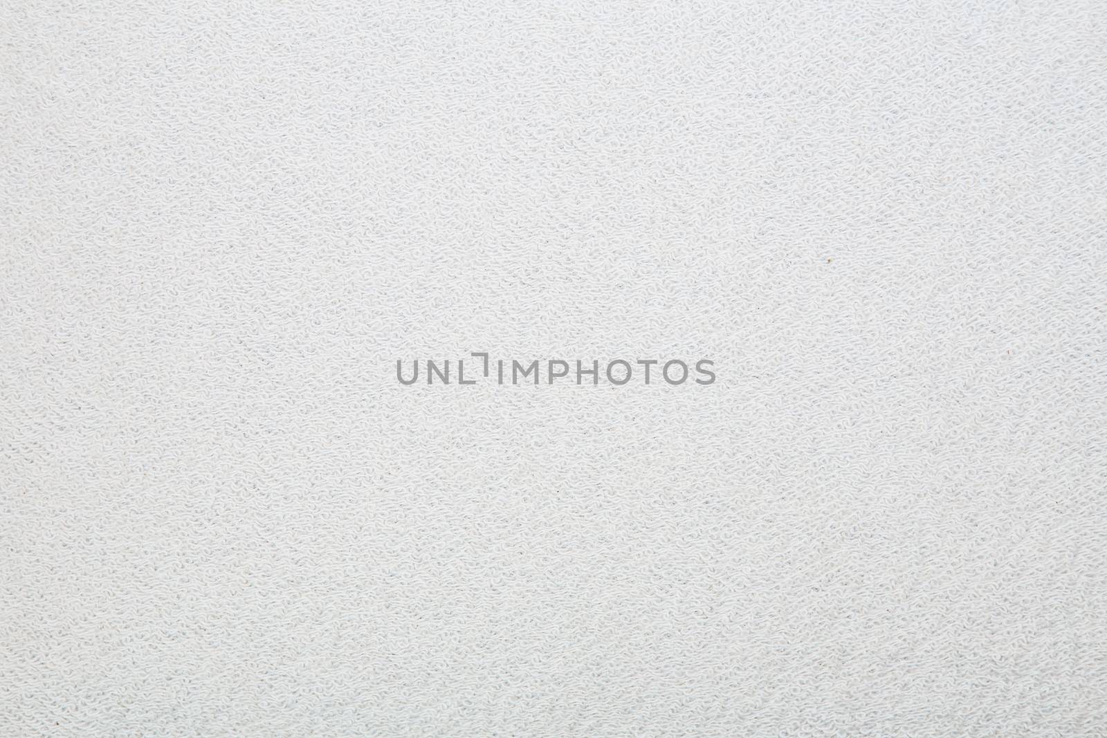 Macro shot of a terrycloth texture background. white Textile floor covering. Grey Knotted-pile carpet