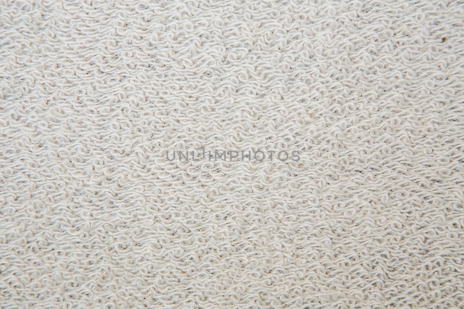 Macro shot of a terrycloth texture background. white Textile floor covering. Grey Knotted-pile carpet