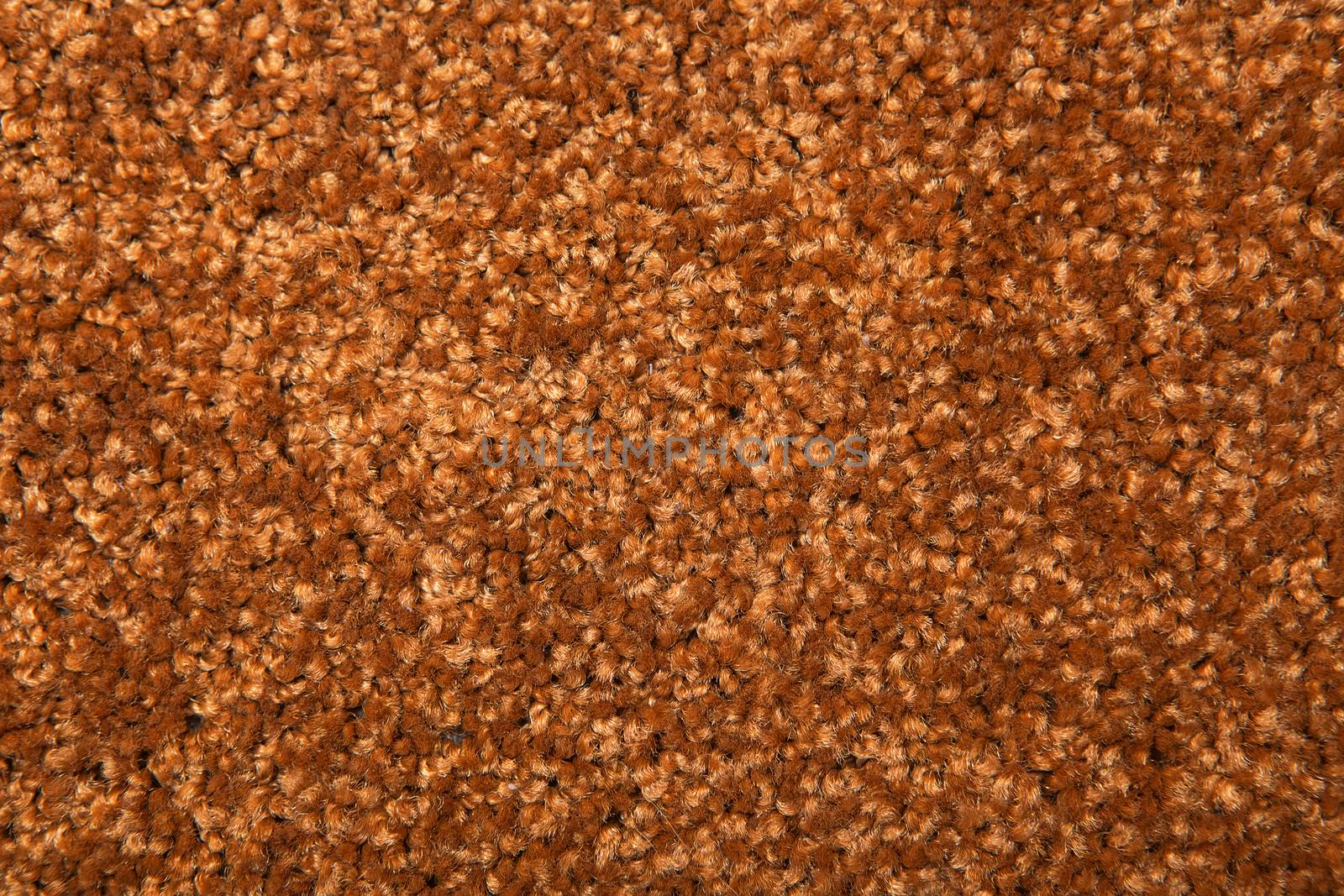 Macro shot of a carpeting texture background. Textile floor covering. Brown Knotted-pile carpet