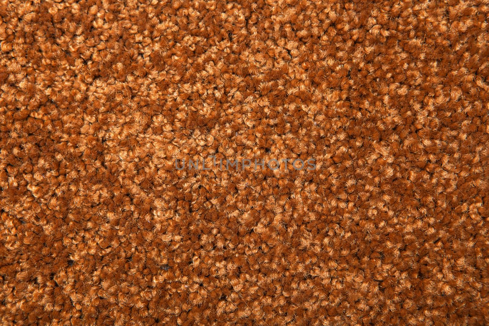 Macro shot of a carpeting texture background. Textile floor covering. Brown Knotted-pile carpet