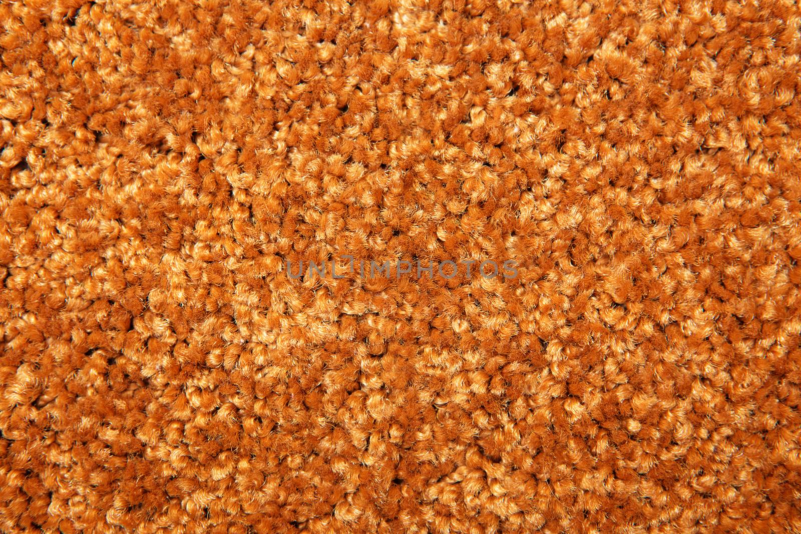 Macro shot of a carpeting texture background. Textile floor covering. Brown Knotted-pile carpet