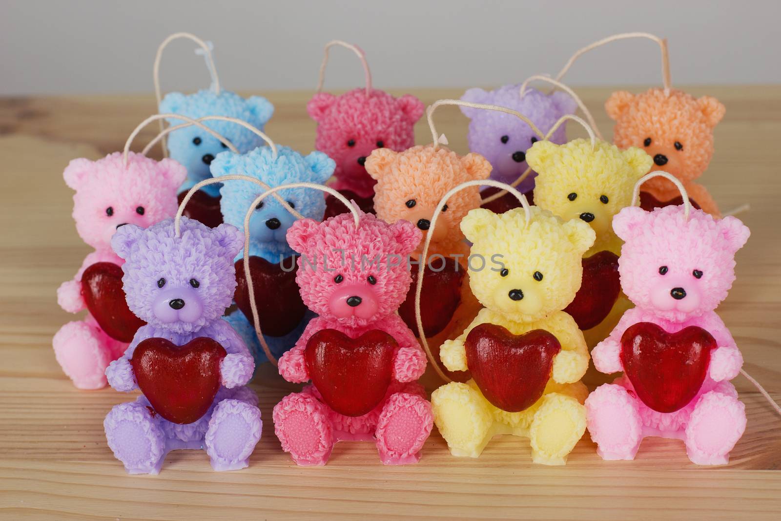 Funny Souvenir gift candles in the shape of teddy-bear with red heart. St. valentine's day.