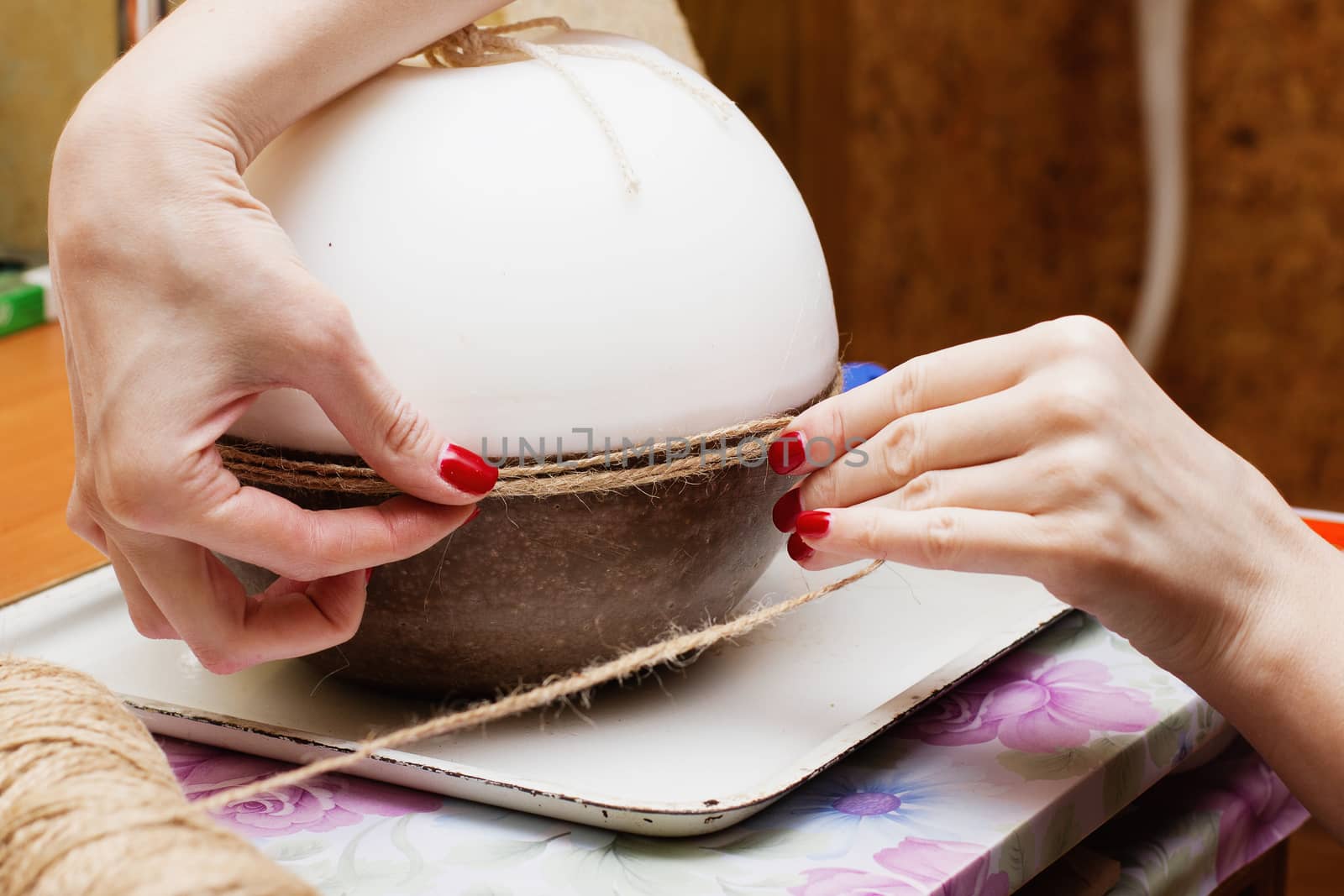 Female hands decorating handmade candles