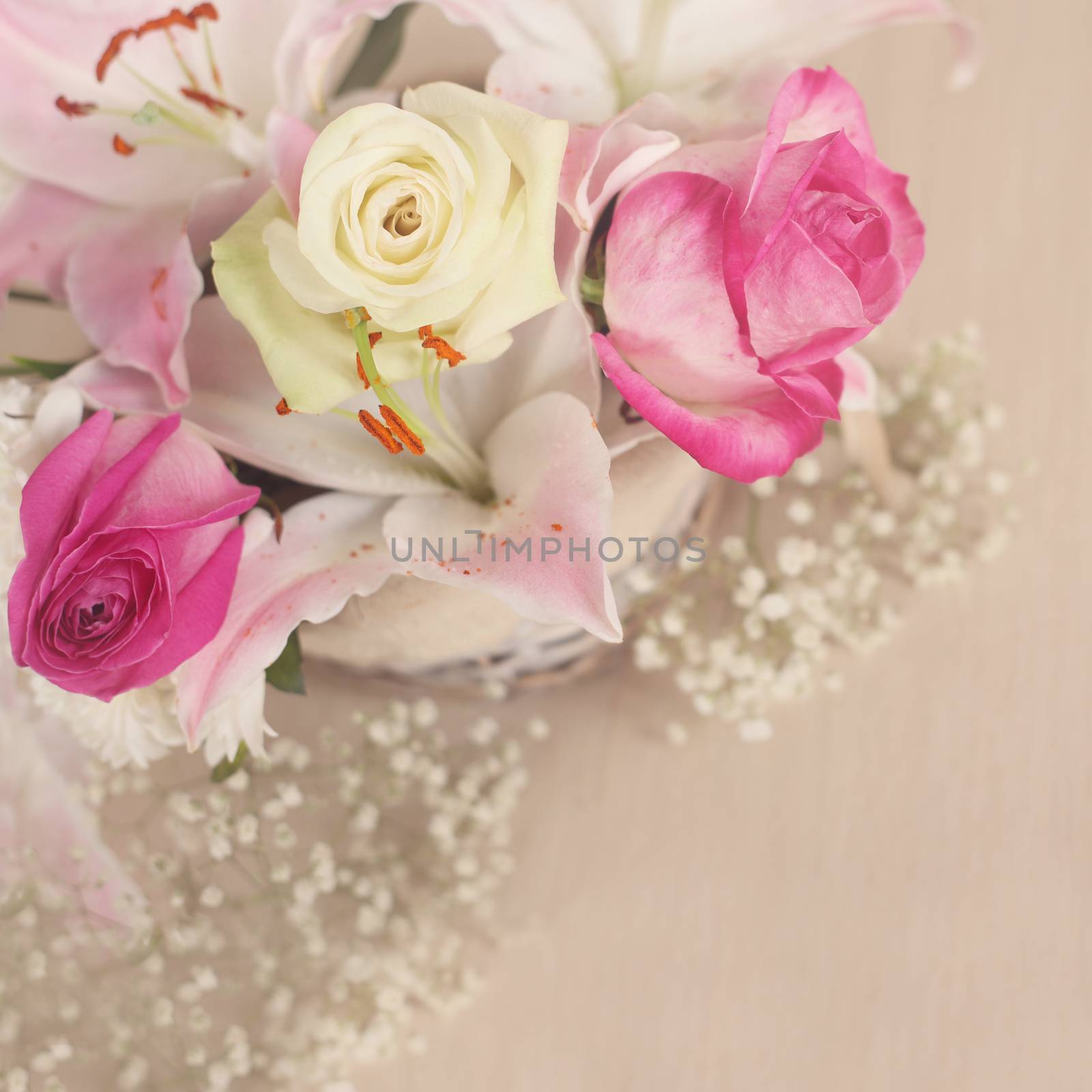 Beautiful bouquet of flowers in basket on wooden background, Valentines day gift concept