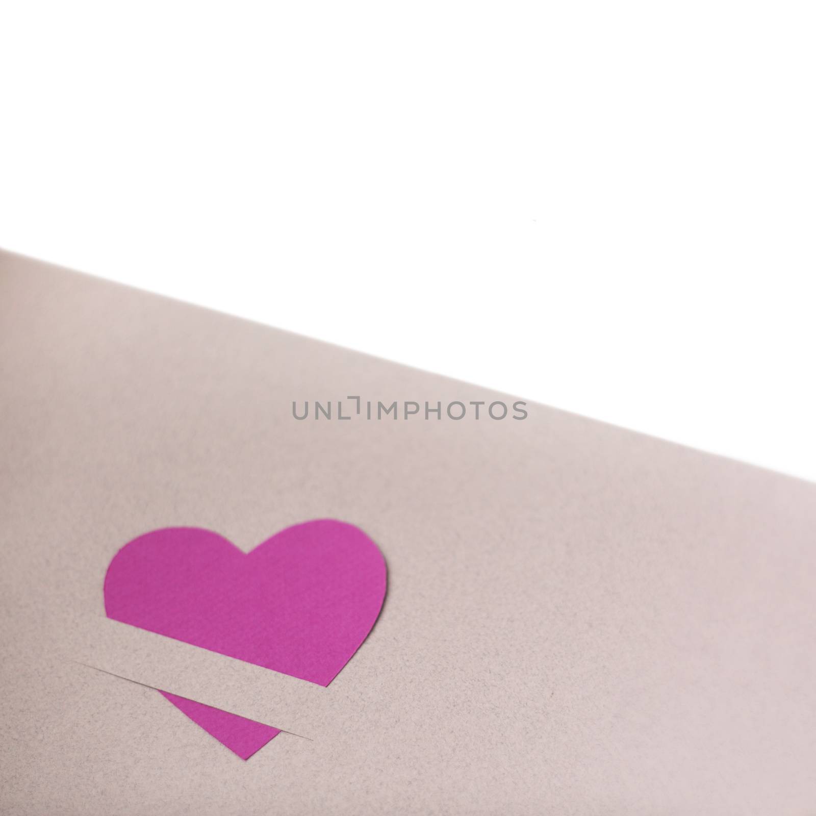 Pink paper hearts on light paper textured background