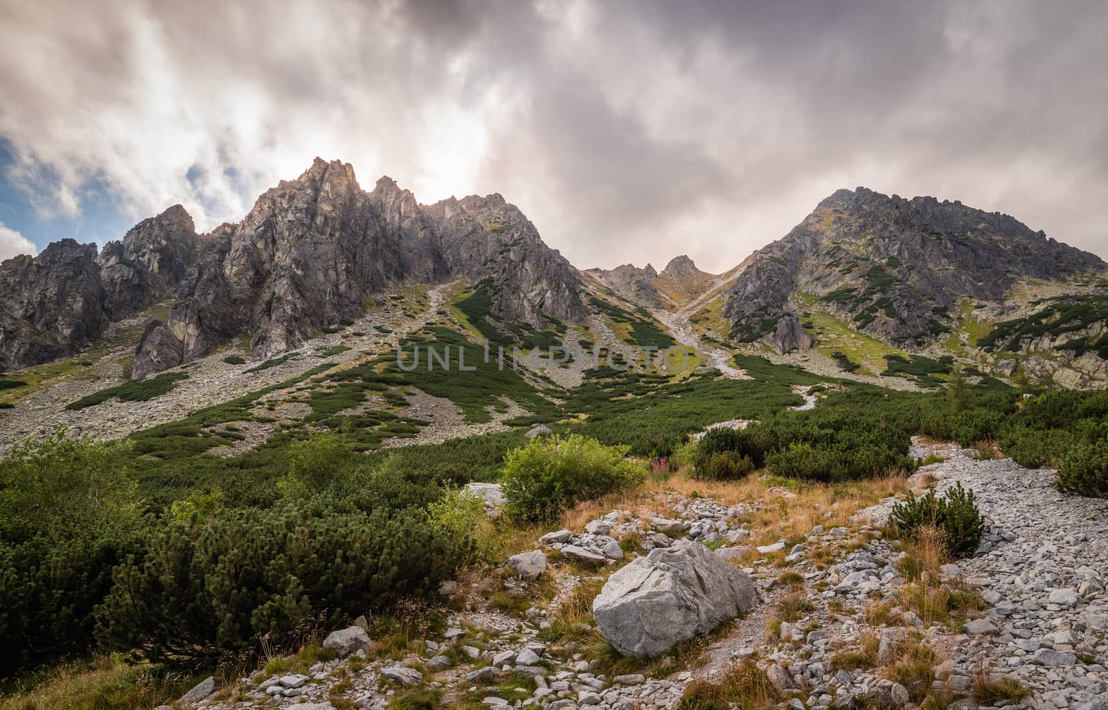 Mountain Landscape with Dramatic Glowing Sky and Sun Shining From Behind the Peaks. Mlynicka Valley, High Tatra, Slovakia.