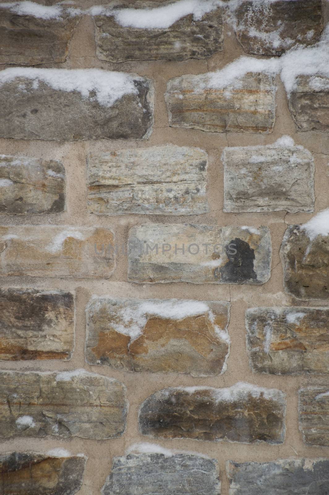 Wintry stone wall background with mortar