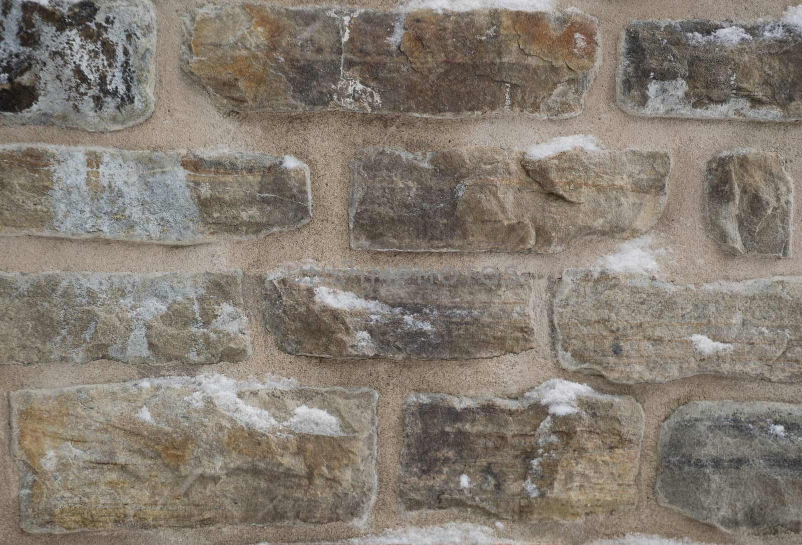 Wintry stone wall background with mortar