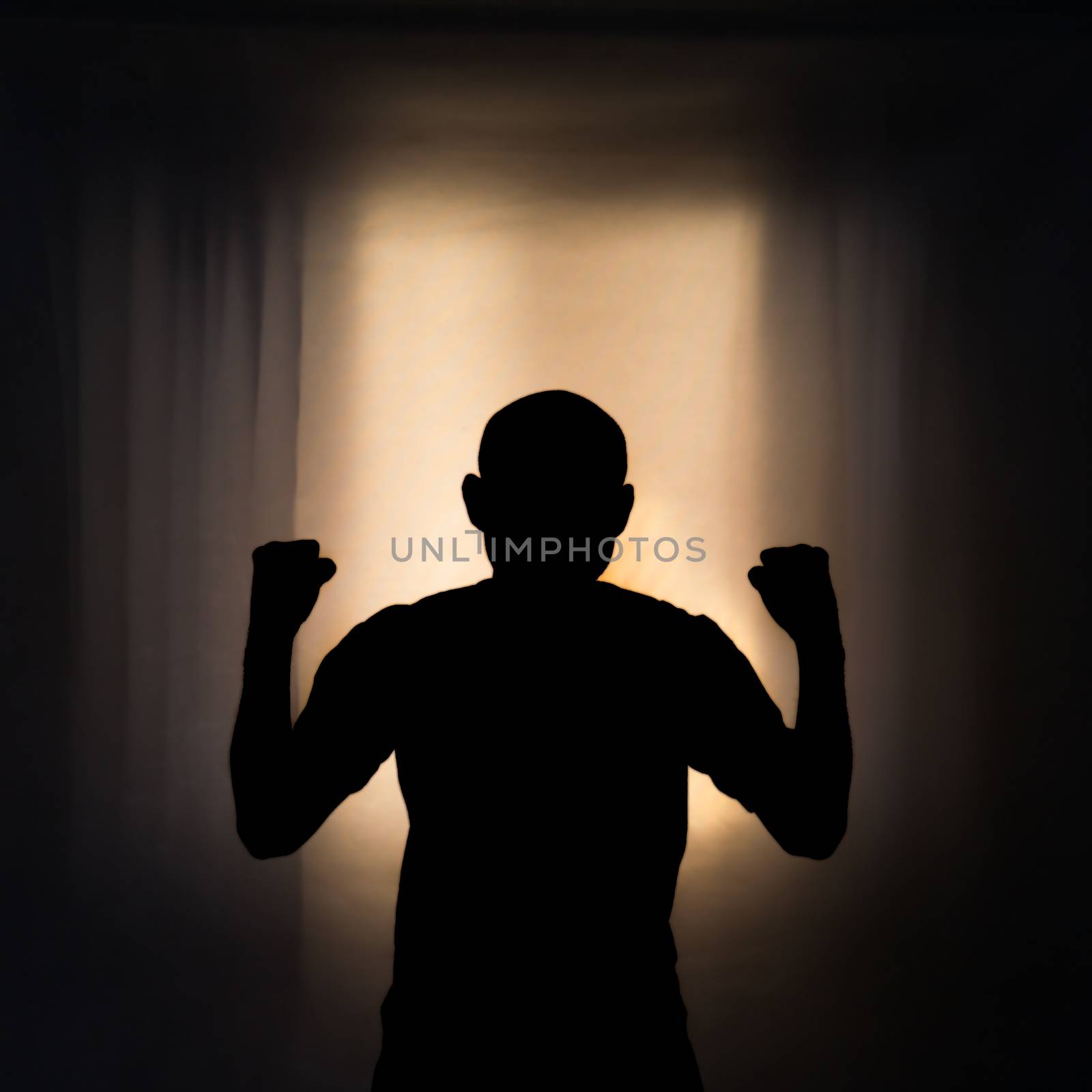 Silhouette of angry man with light from window background