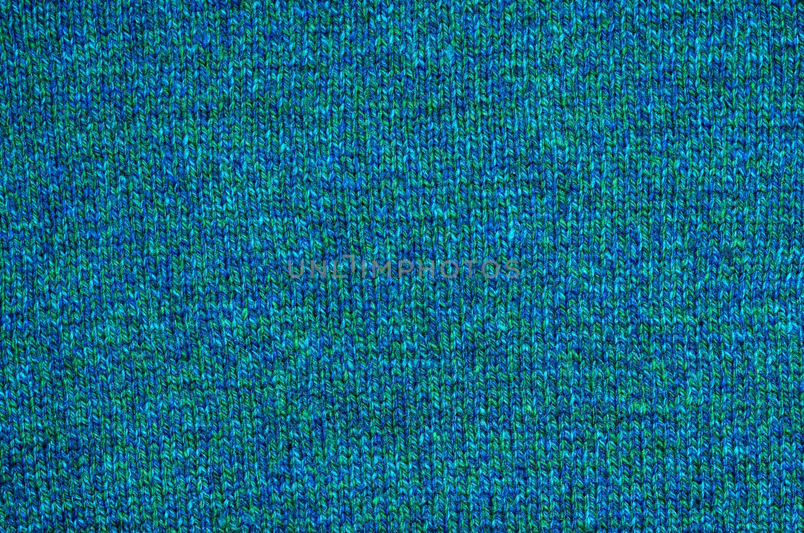 The background of the knitted fabrics of coarse woolen yarn blue and green shades.