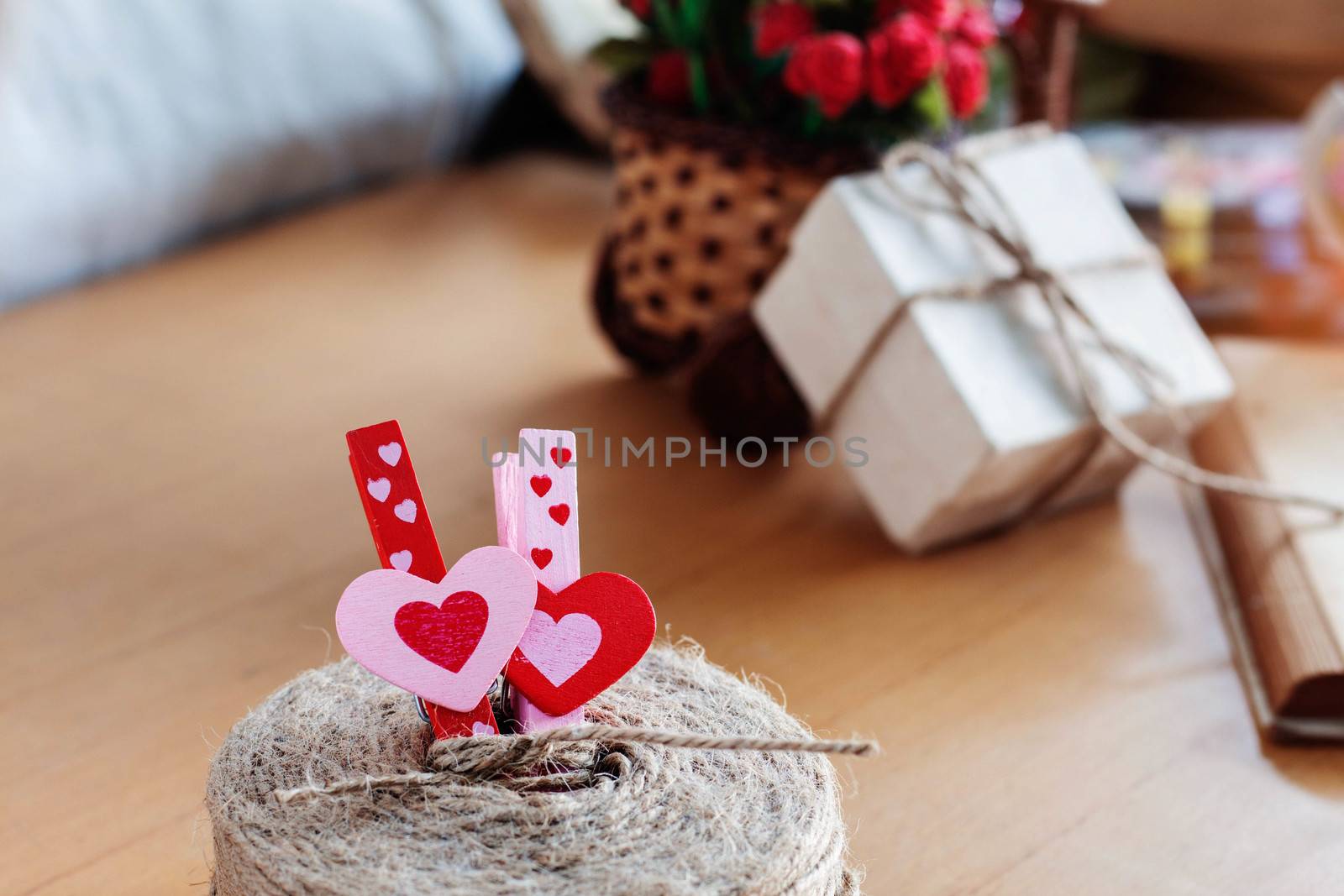 Colorful heart of pin and gifts on the desk.