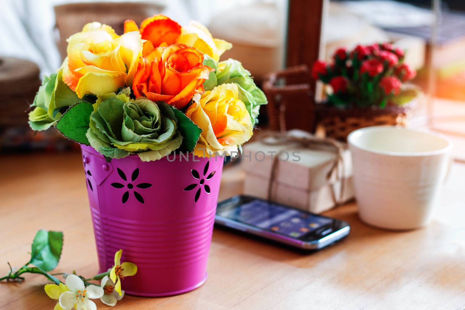 Colorful roses in a vase on the desk.