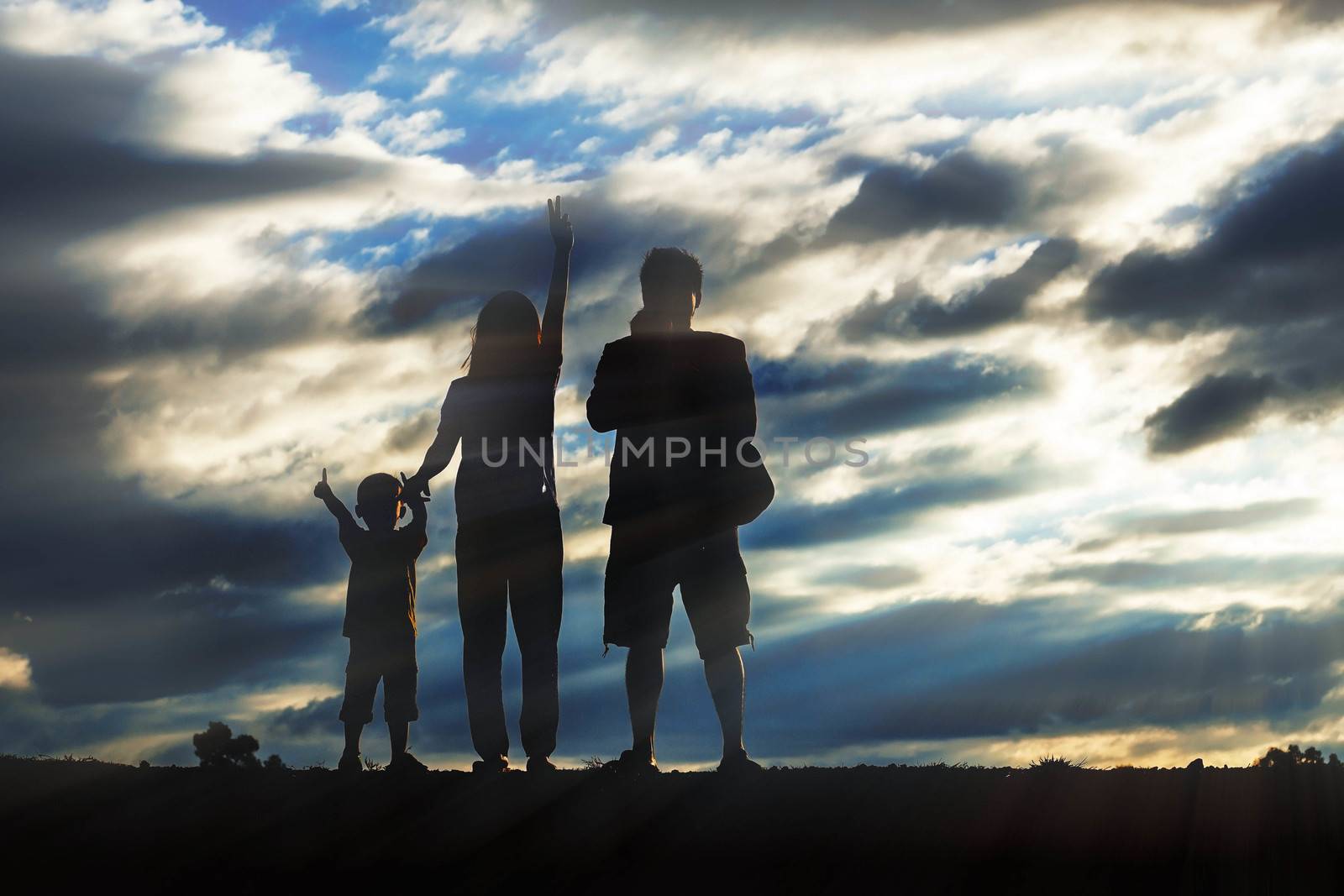 Parents and children with silhouettes at sunset.