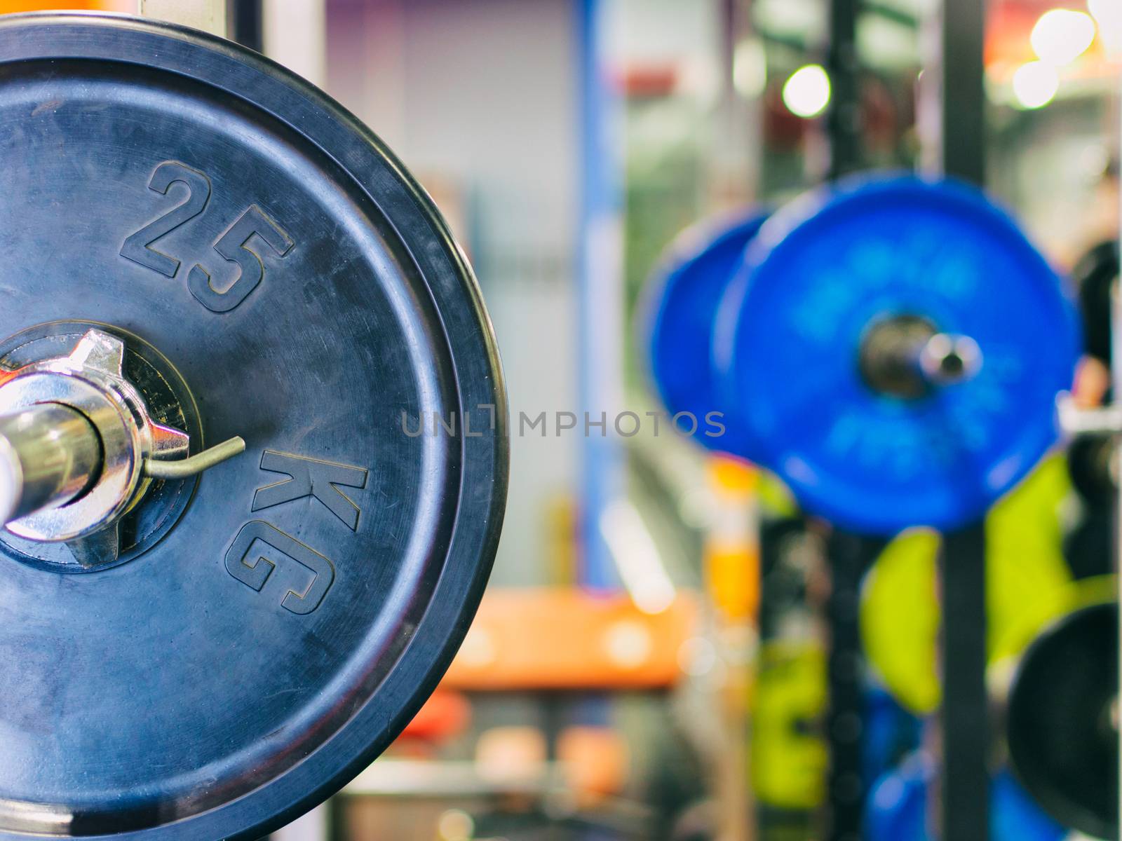 Barbell ready to workout in gym. Shallow DOF. Copy space. Sport or powerlifting background.