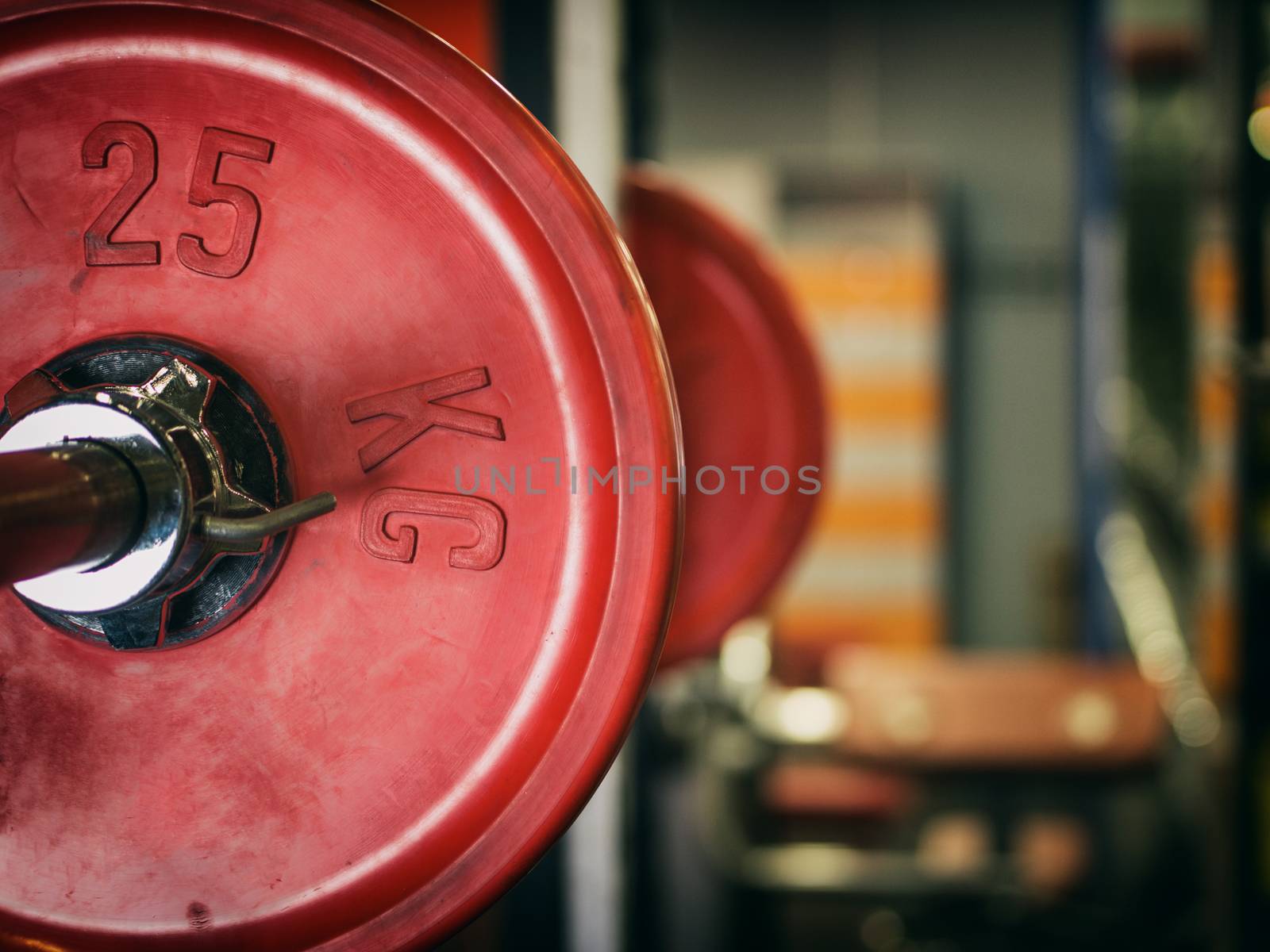 Barbell ready to workout in gym. Shallow DOF. Copy space. Sport or powerlifting background. Toned image.