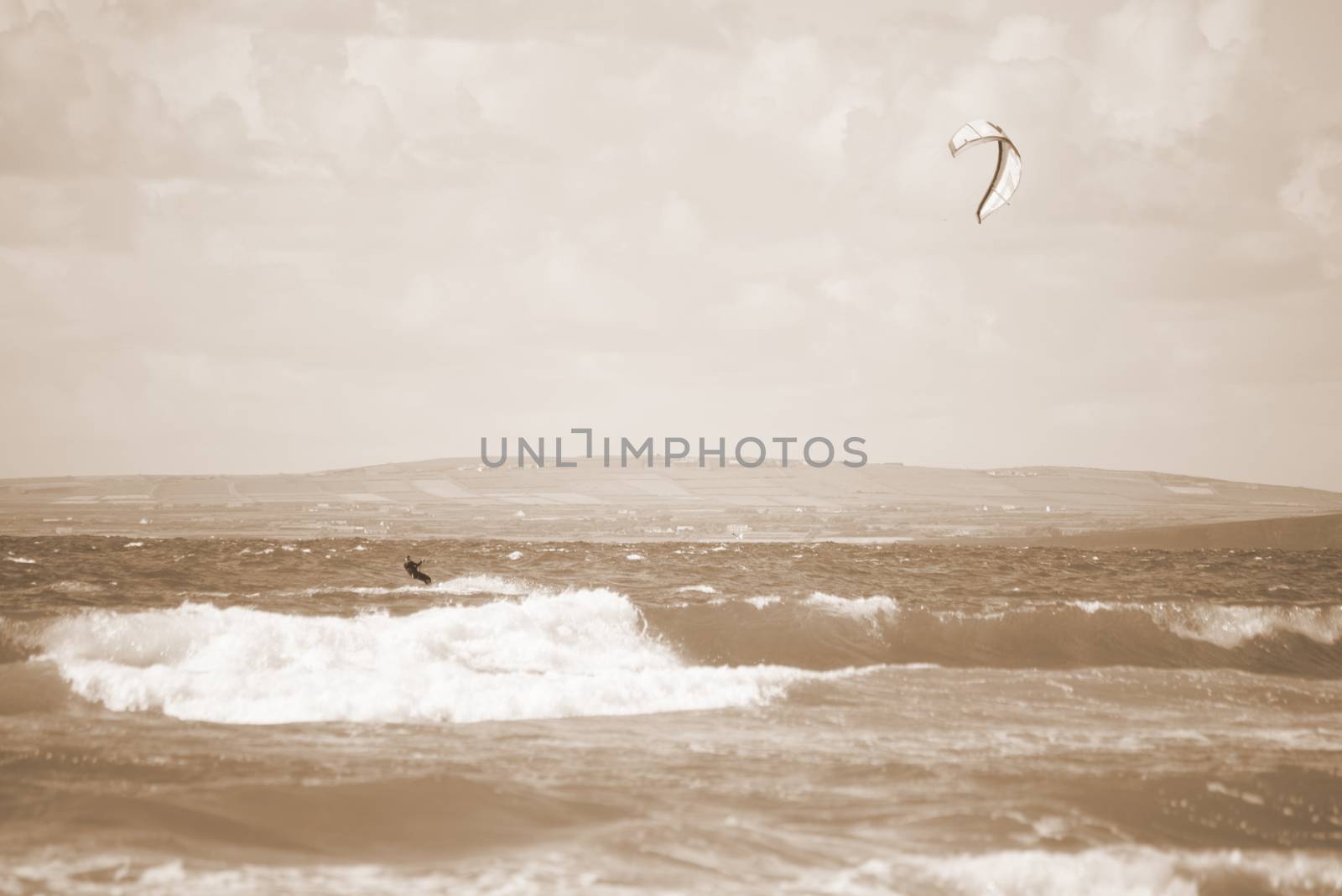 sepia kite surfer on beautiful waves by morrbyte