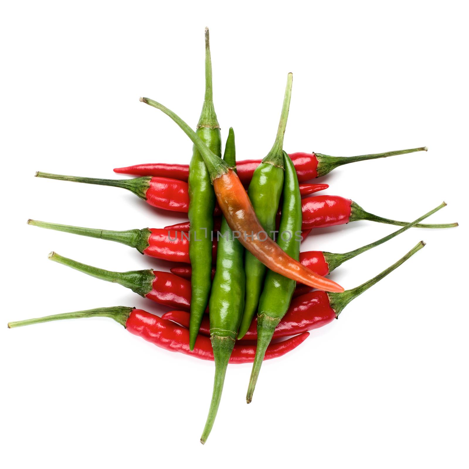 Arrangement of Perfect Red, Orange and Green Hot Chili Peppers closeup on White background