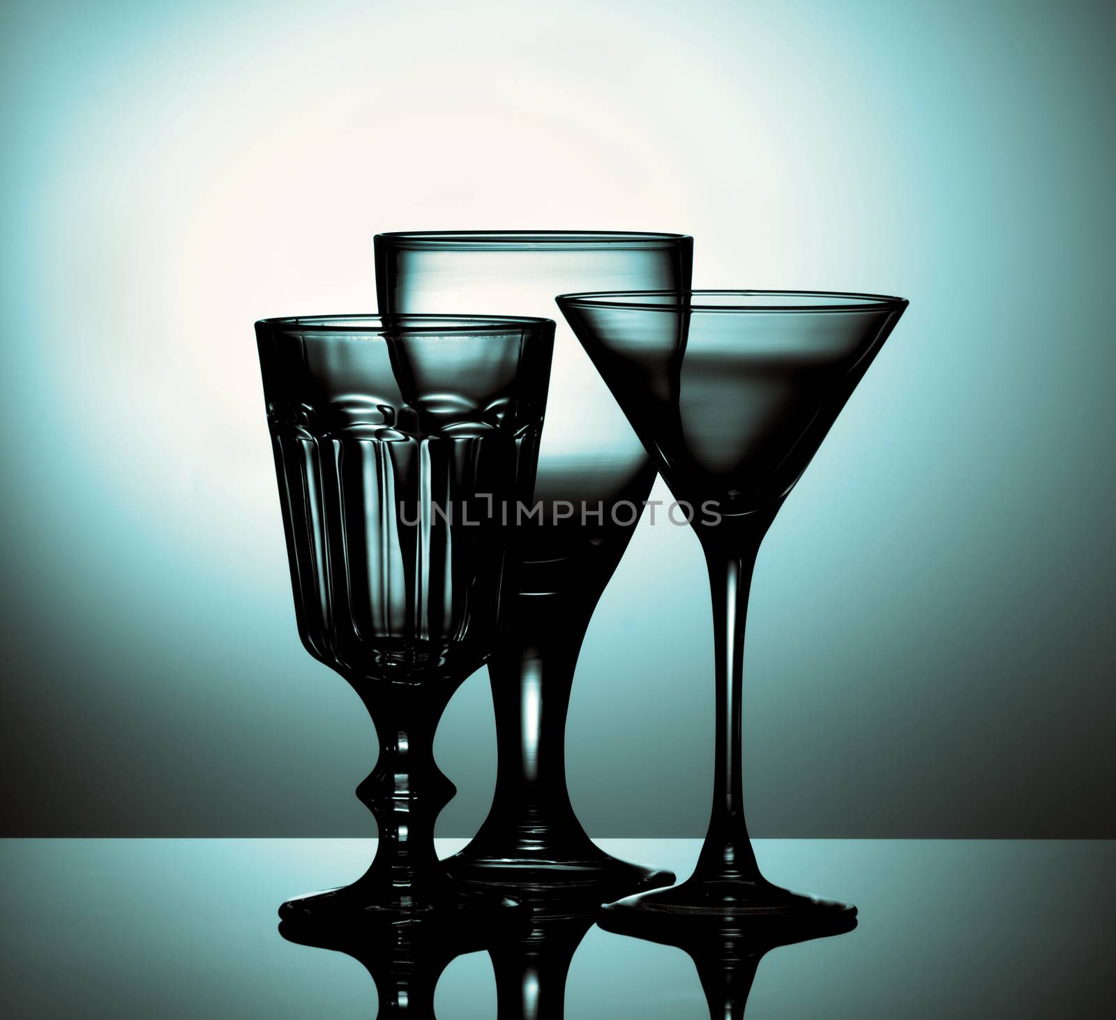 Three Various Empty Wine Glasses for Wine and Martini with Reflection on Glass and Shadow Backlight. Turquoise Toned