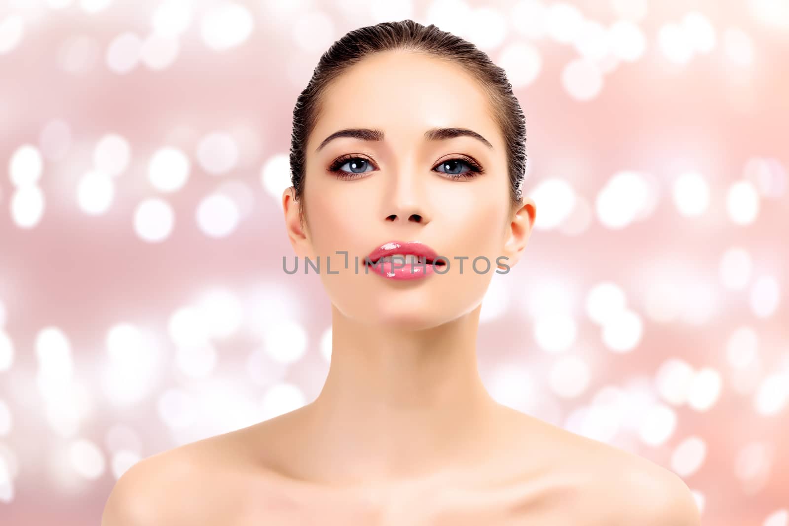 Beautiful young lady on an abstract background with blurred lights